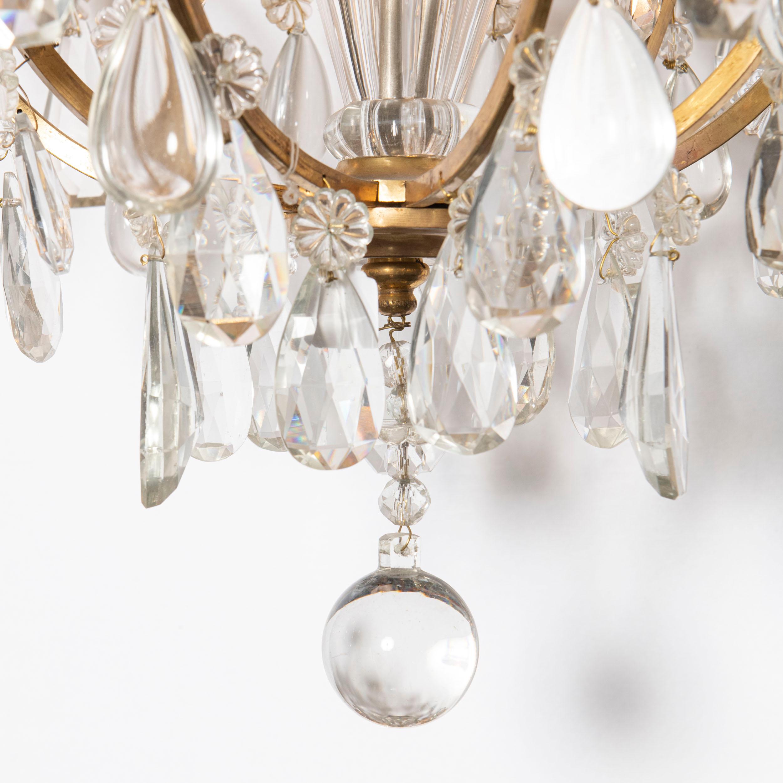Mid-Century Modern Pair of bronze and crystal chandeliers. France, circa 1940. For Sale