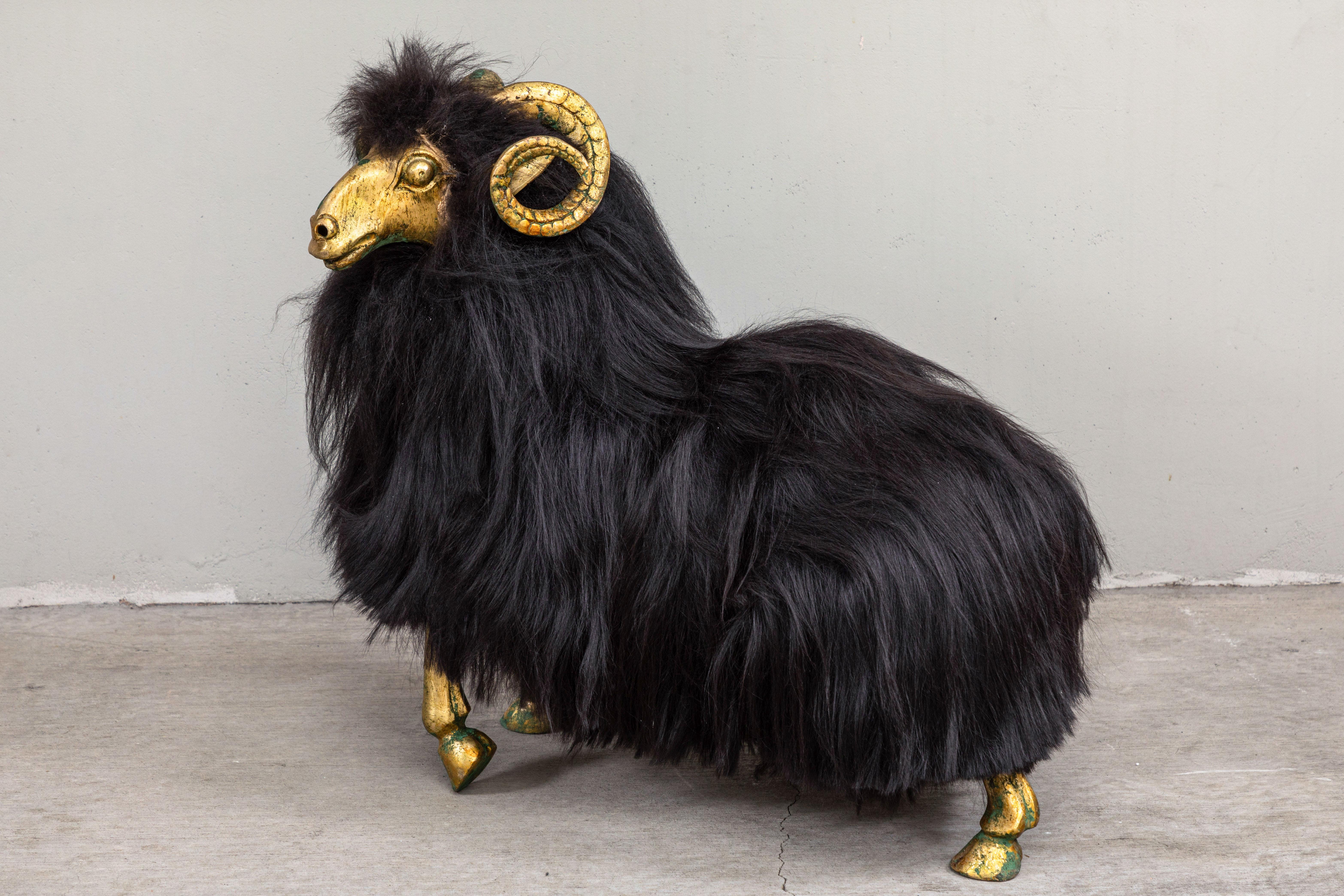 Striking pair of bronze sheep sculptures with long black Icelandic sheep fur. Whimsical and playful, these make striking statement pieces in a variety of settings.