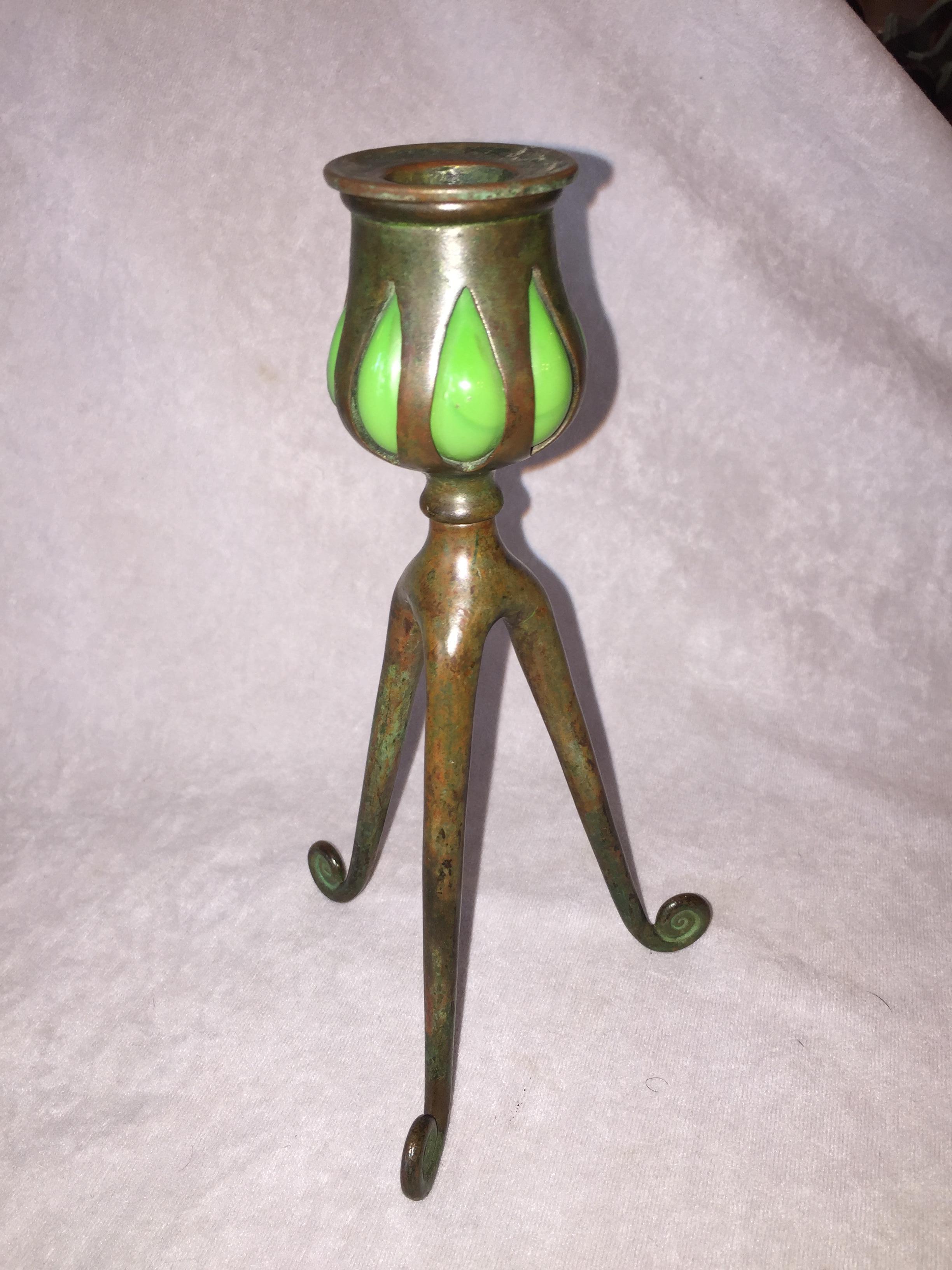 These charming little candlesticks were done by the most recognized maker of quality craftsmanship of the period, Tiffany Studios. Besides the famous leaded glass lamps that the studio produced, there were many other useful and interesting items for