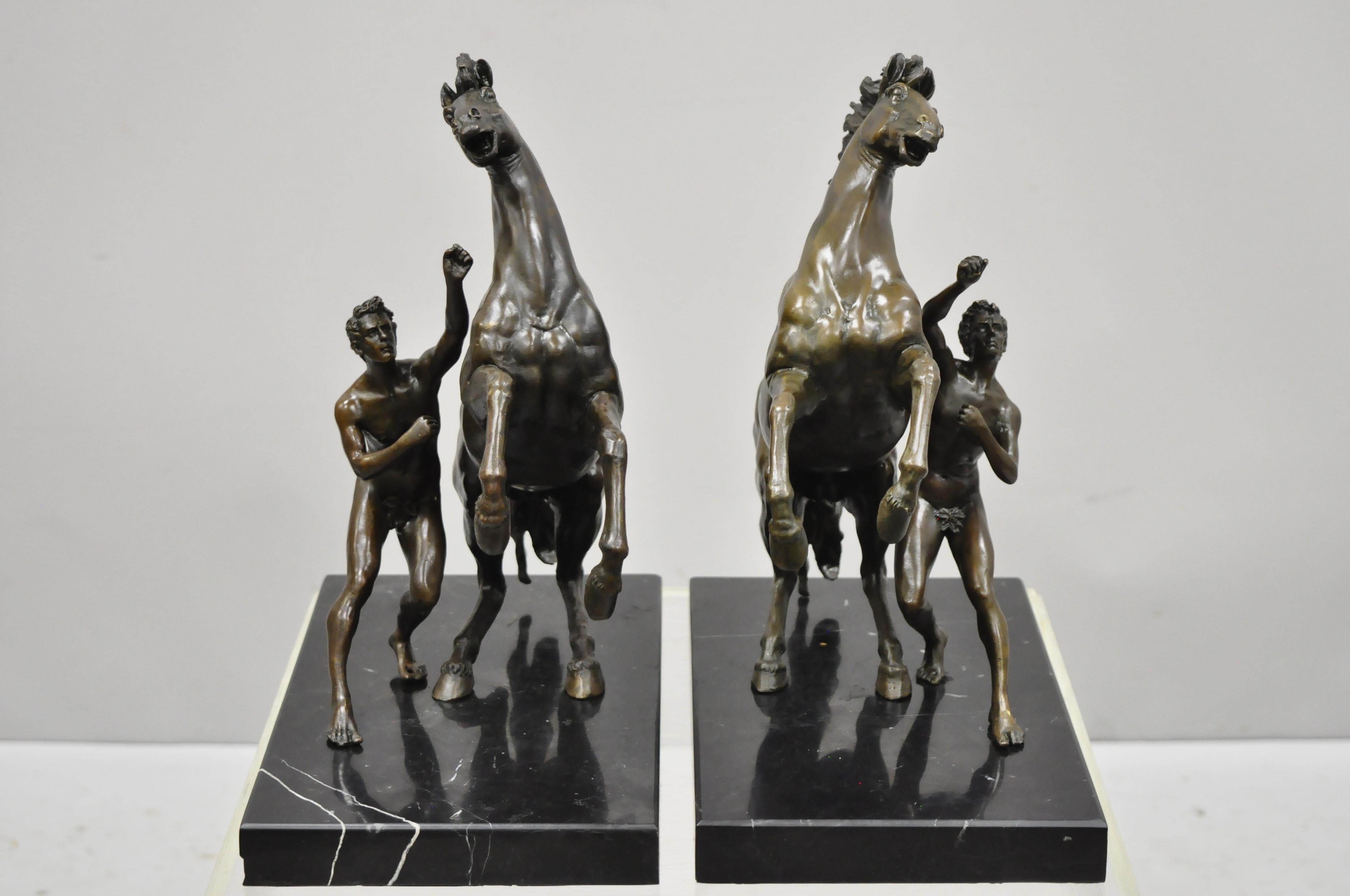 Pair of bronze and marble Marly Horse and Tamer sculpture statues after Coustou, circa late 20th century. Measurements: 14