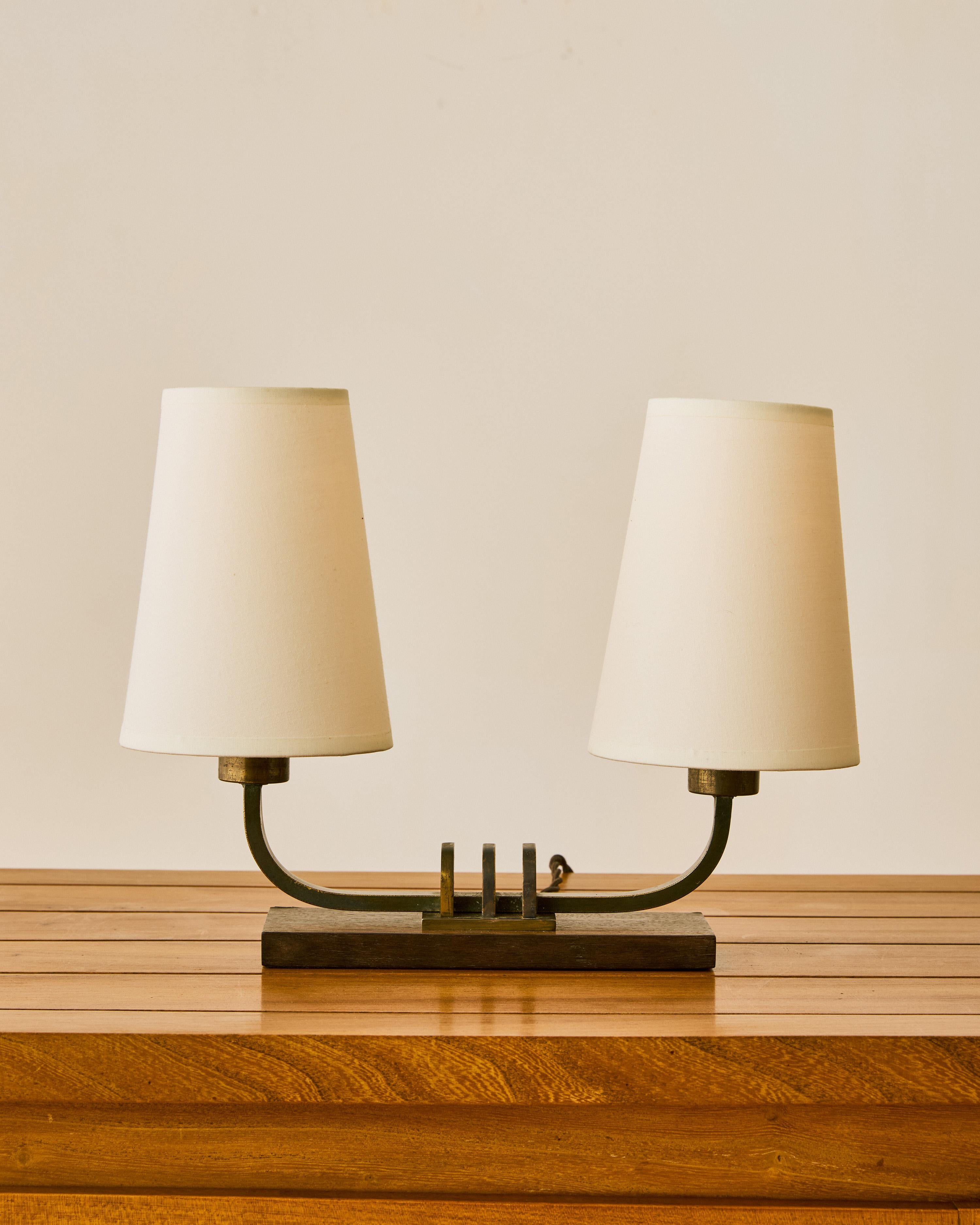Pair of solid bronze and rosewood double headed table lamps with new custom shades.