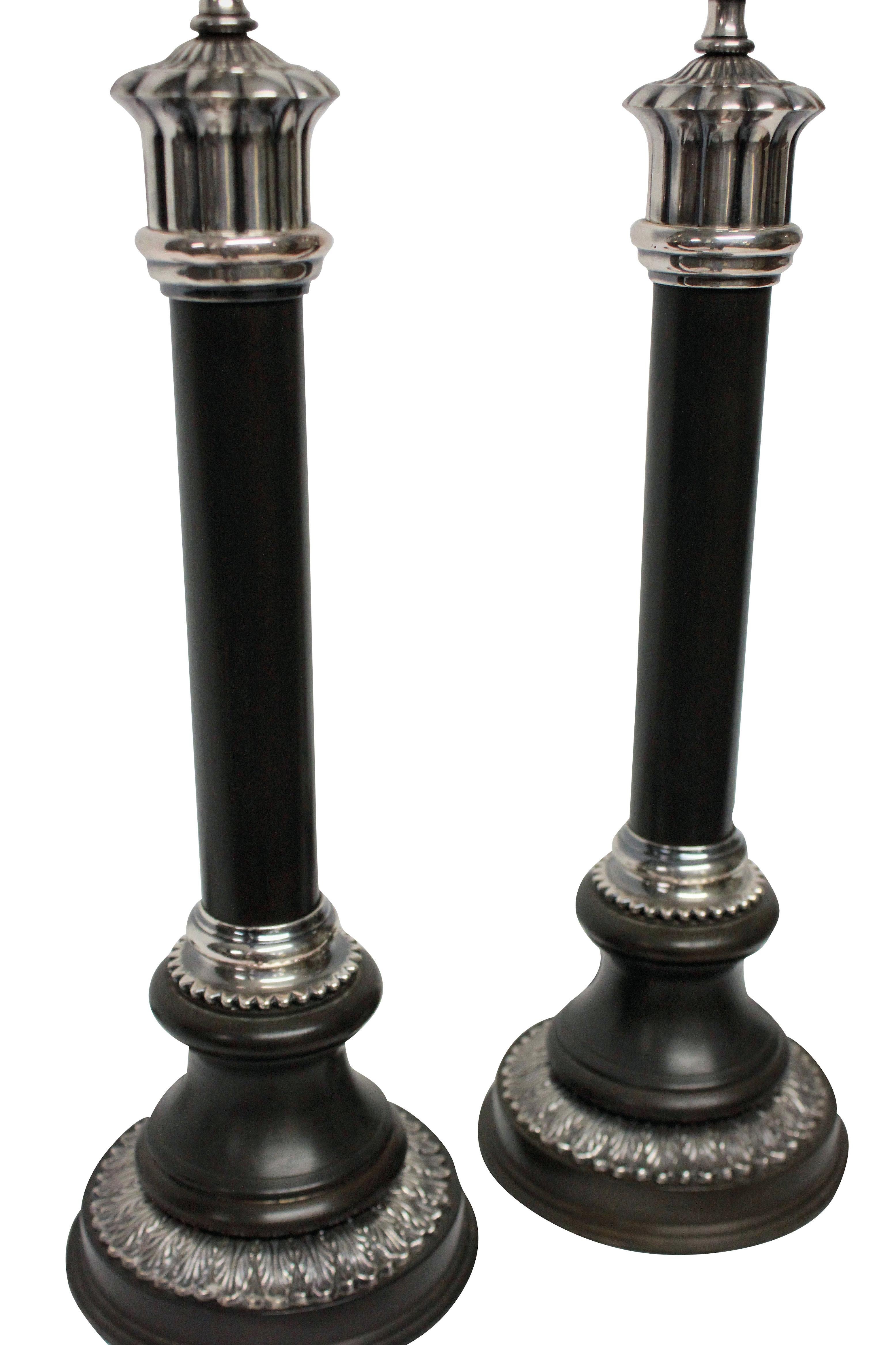 A pair of English bronzed and silver plated neoclassical column table lamps.