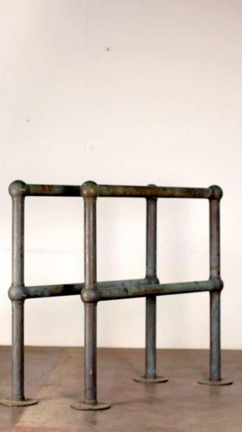 Pair of bronze architectural railings. Measures: 2 1/2 inch diameter sections. The floor plate is 8 in. in diameter.