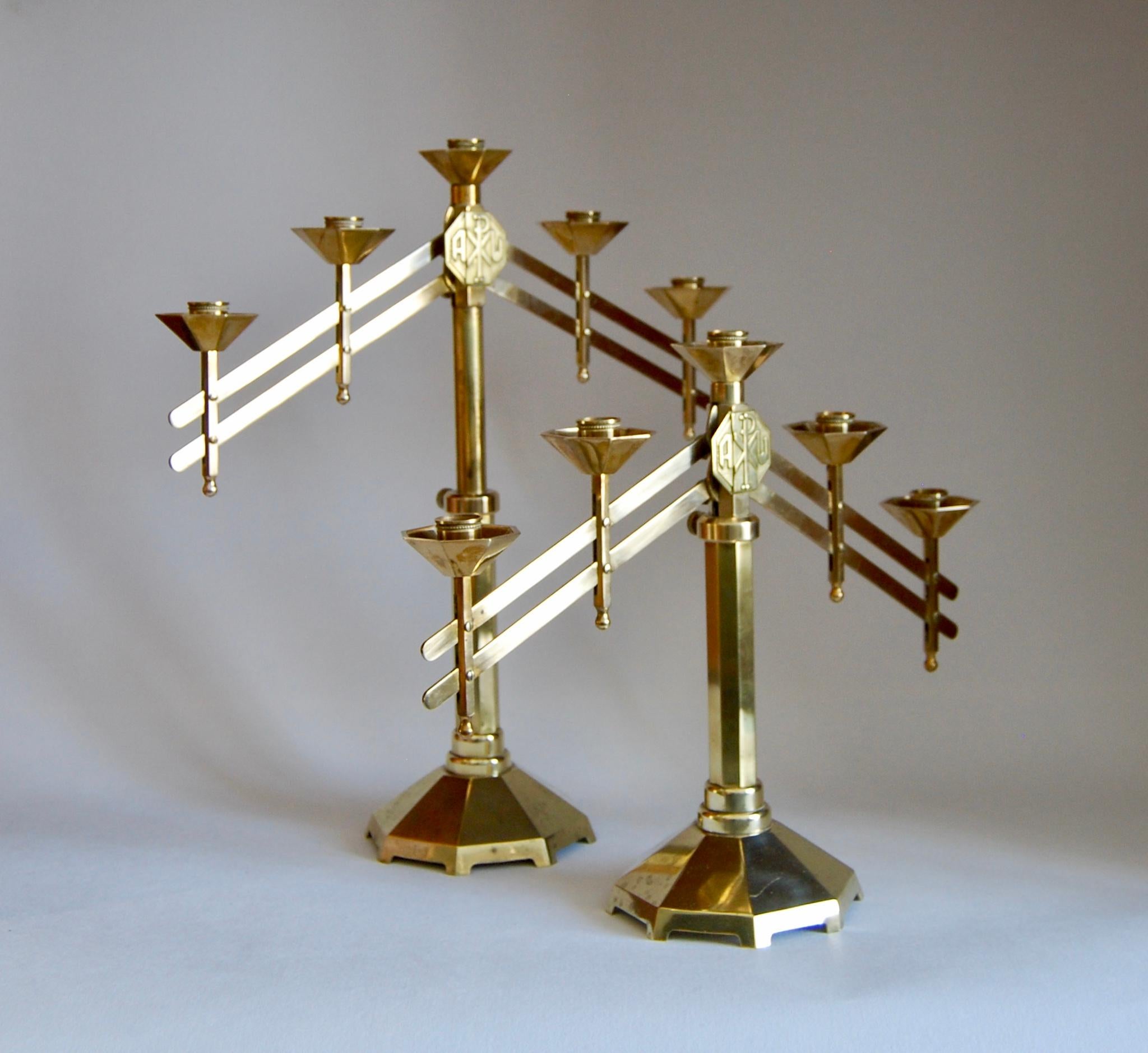 A strikingly impressive pair of French art deco altar candelabras in bronze
Each has five candle holders, their articulated arms can be altered to complement their setting as desired
The centre decoration on each represents the Easter
