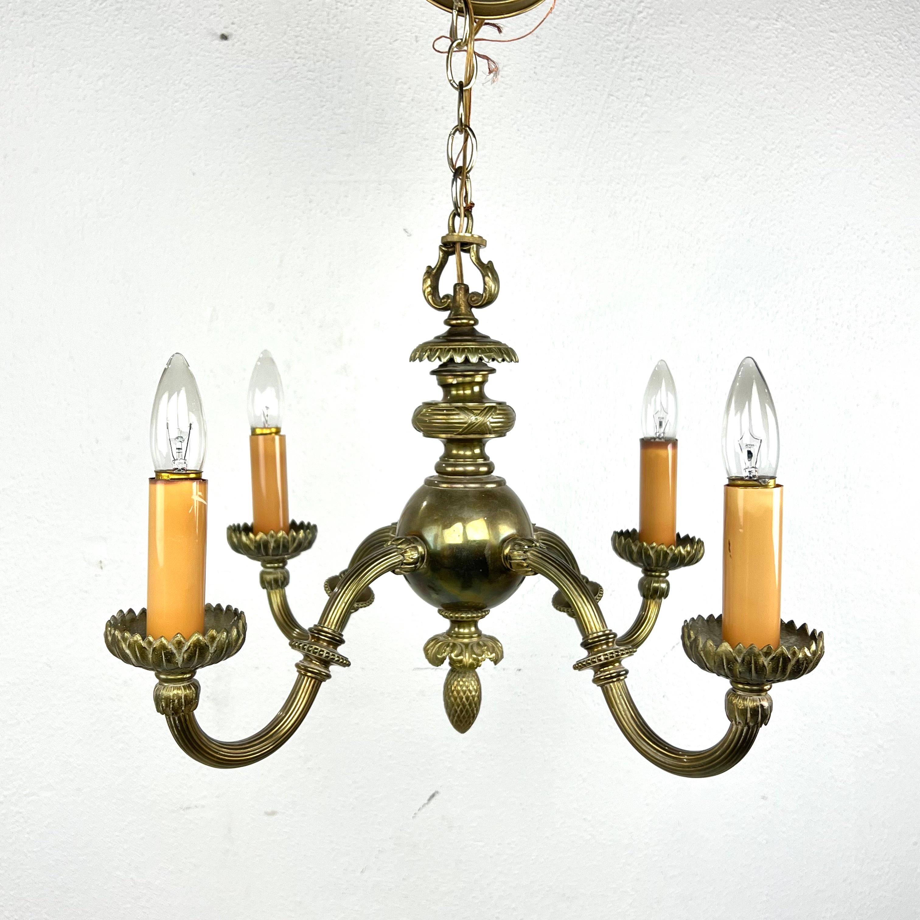 Pair of elegant early 20th Century bronze art nouveau chandeliers. Solid cast bronze with 4 substantial arms featuring sculpted lotus flowers. A rare and unique set. 