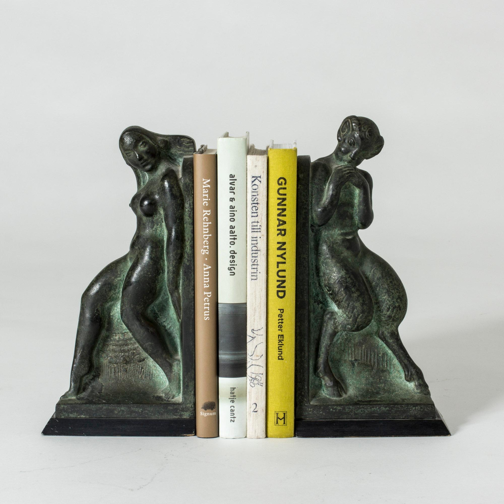 Pair of gorgeous patinated bronze bookends by Axel Gute. They are in the shape of Syrinx and Pan from Greek mythology, beautifully made so that one can really imagine the story that is played out between them.