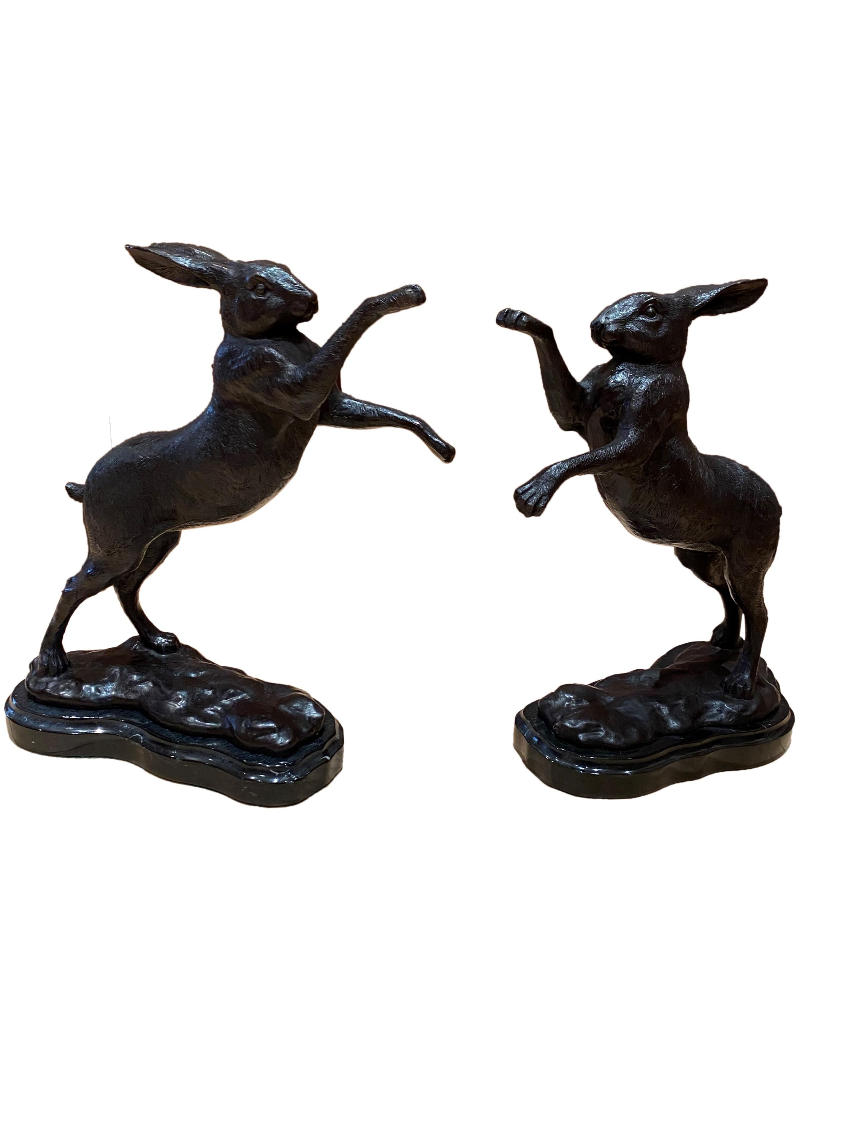 A gorgeous pair of bronze boxing hares, 20th century. 'Boxing Hares' bronze sculptures are a pair of long eared brown hares caught mid boxing match, fighting in unison. These ‘mad march hares’ as they became known are frequently regarded as the