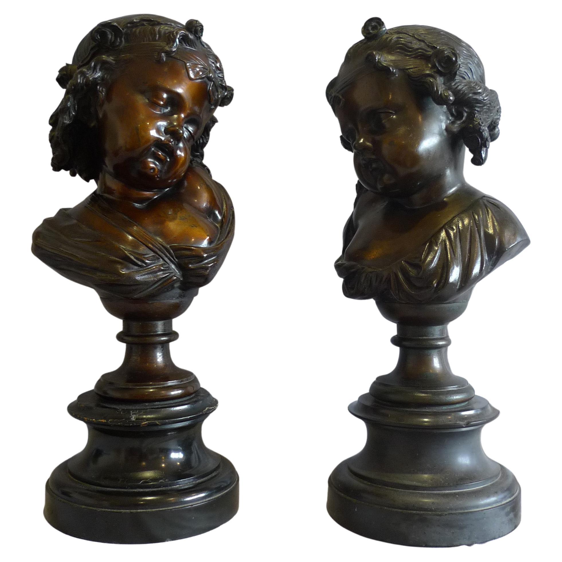 Pair of bronze busts of childs' heads on marble bases. For Sale