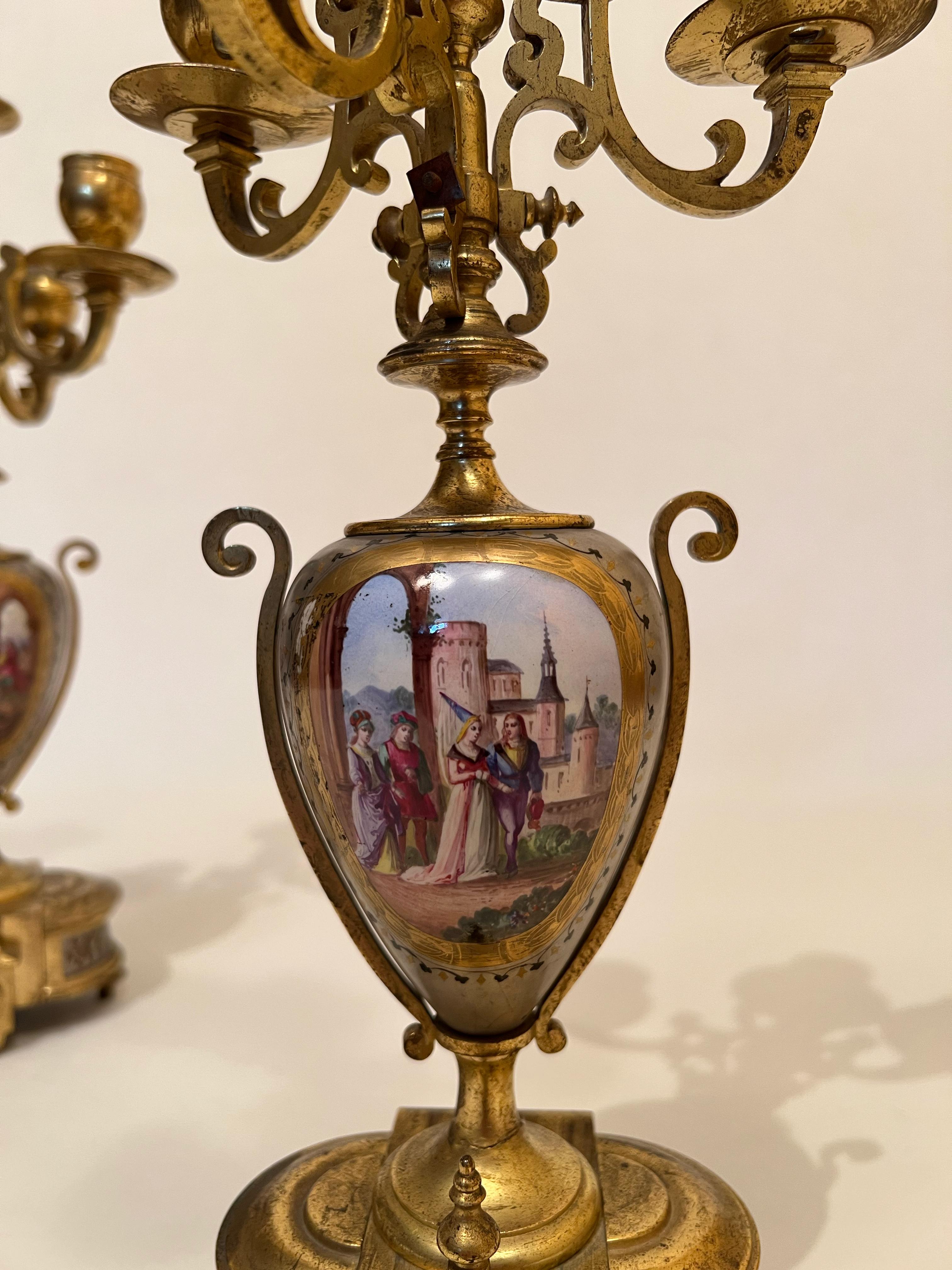 Pair of bronze candelabra with double-sided paintings 19th century. The paintings, finely executed on the bronze with oil tempera, depict noble figures and landscapes. Both painting and manifacture are from the same period. 
Originally created as