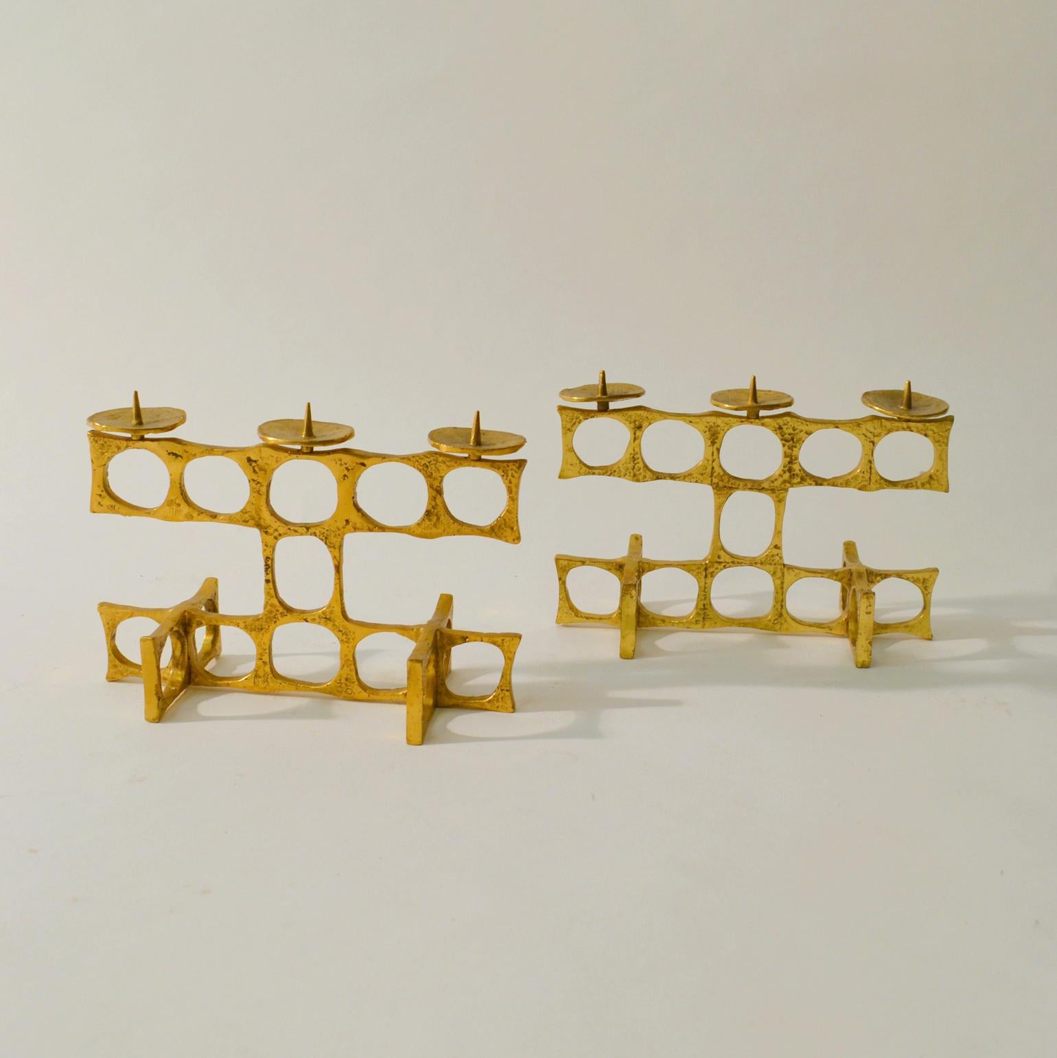 Pair of large brutalist three-light candelabra's are cast in bronze, designed by Austrian artist Heinz Goll. 
Suitable for various size candles up to 4 cm Diameter.