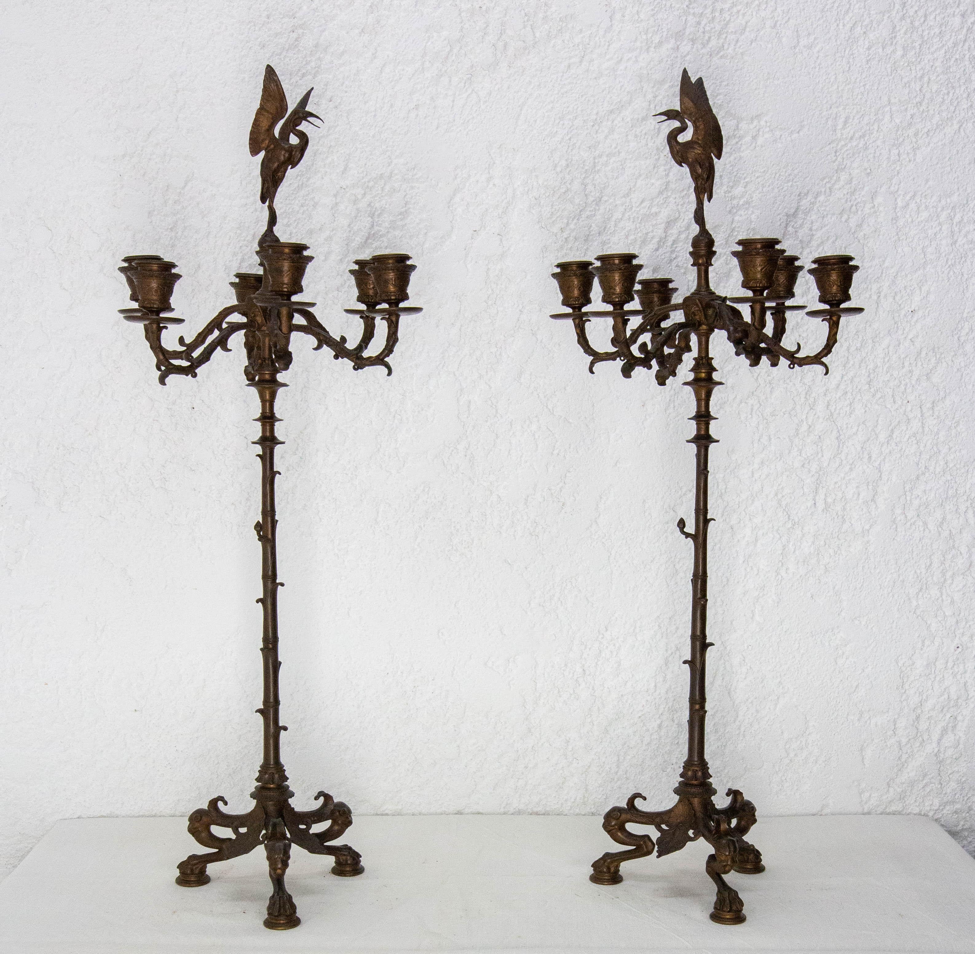 French decorative candle holder 
Pair of large candelabra in patinated bronze. Each antique candlestick is richly decorated. The base is highlighted by openwork foliage, and stands on three claw feet. Each candleholder can support six candles. Each