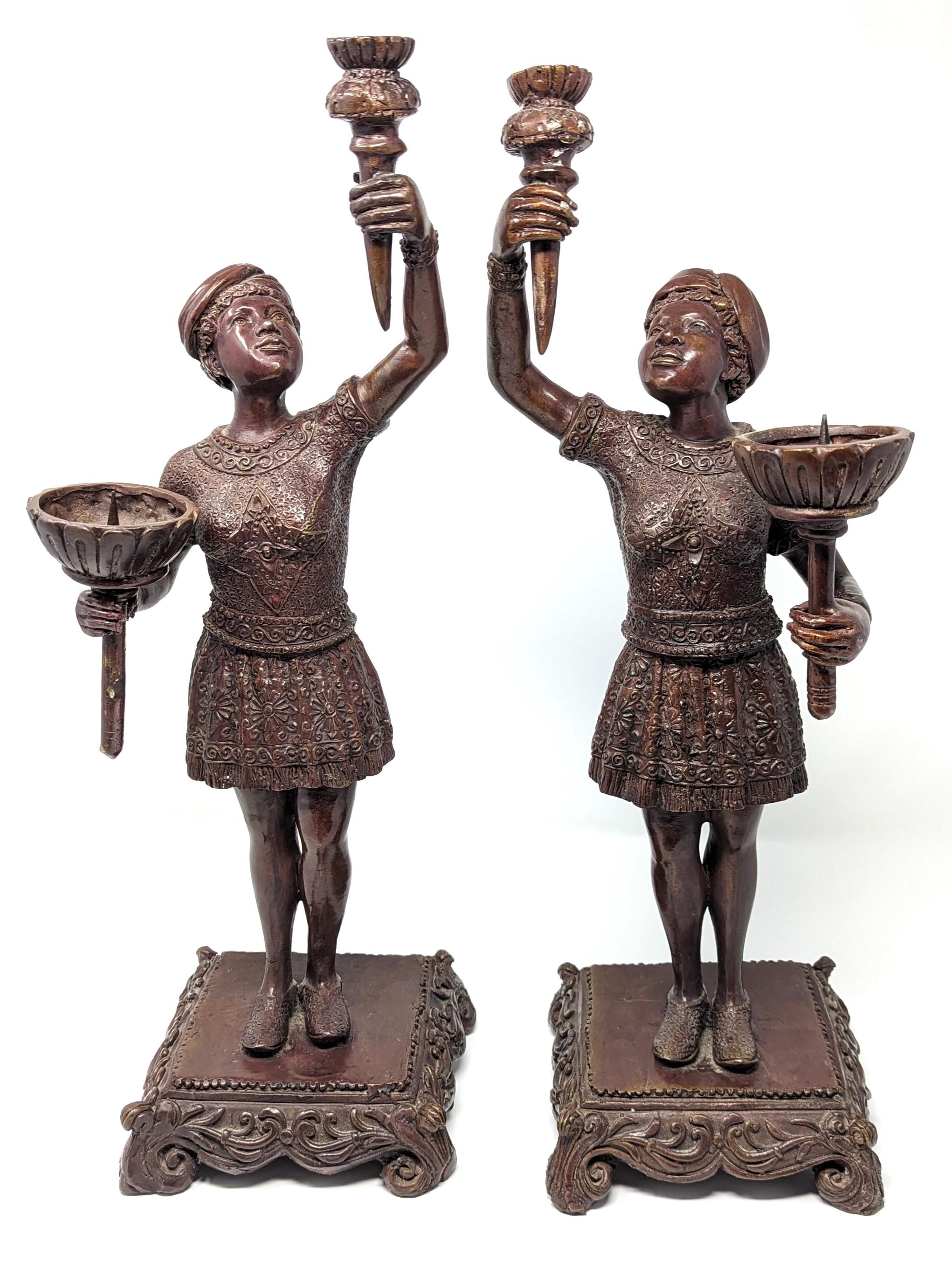 Beautiful pair of bronze candlesticks featuring an Olympic torch bearer. Made from high-quality bronze, making these a unique set to add to your home decor. Measures slightly under 19 inches in height with the base measuring 6 inches in width and 6