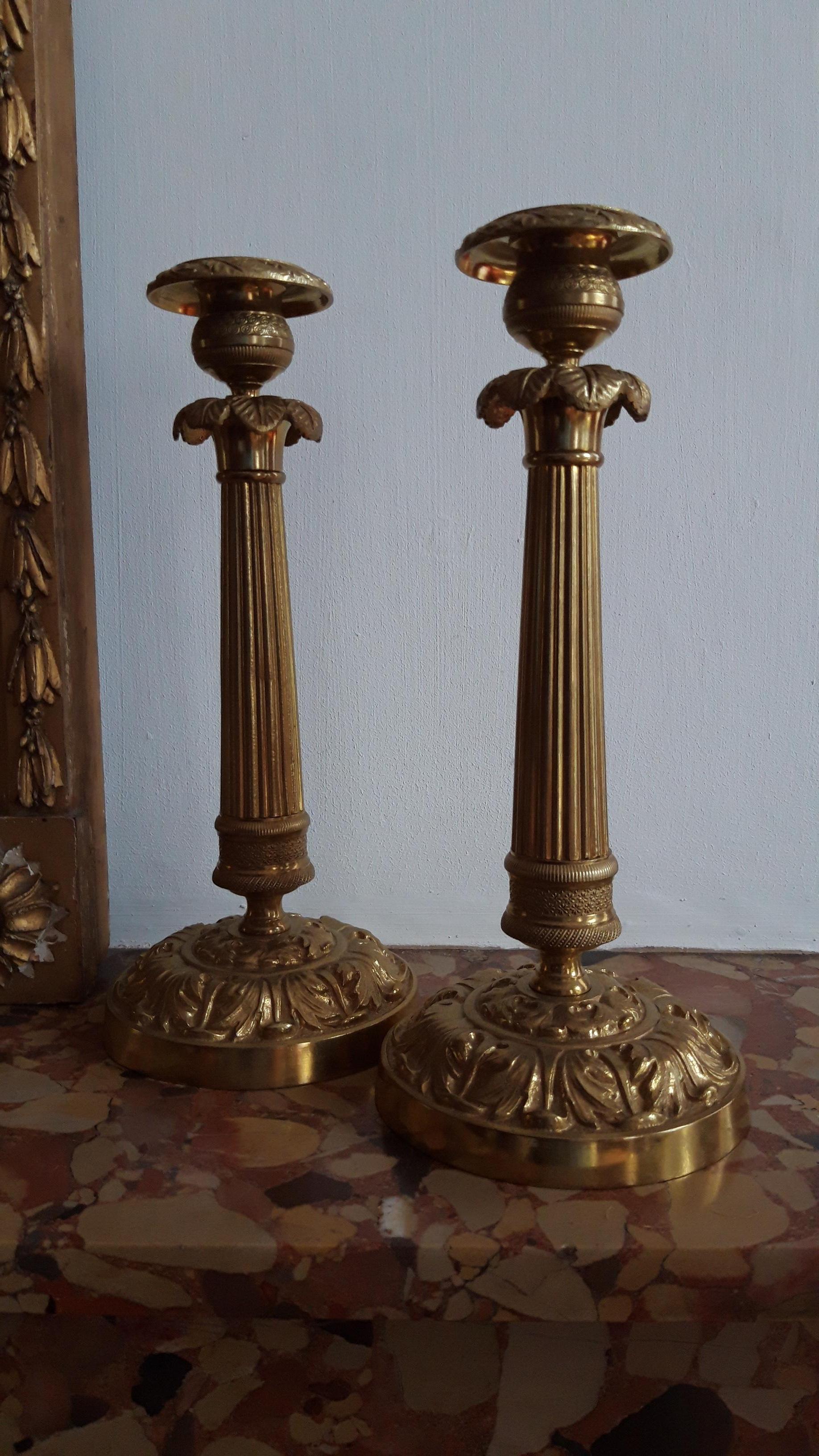 Pair of bronze candlesticks including the often missing nozzles.
