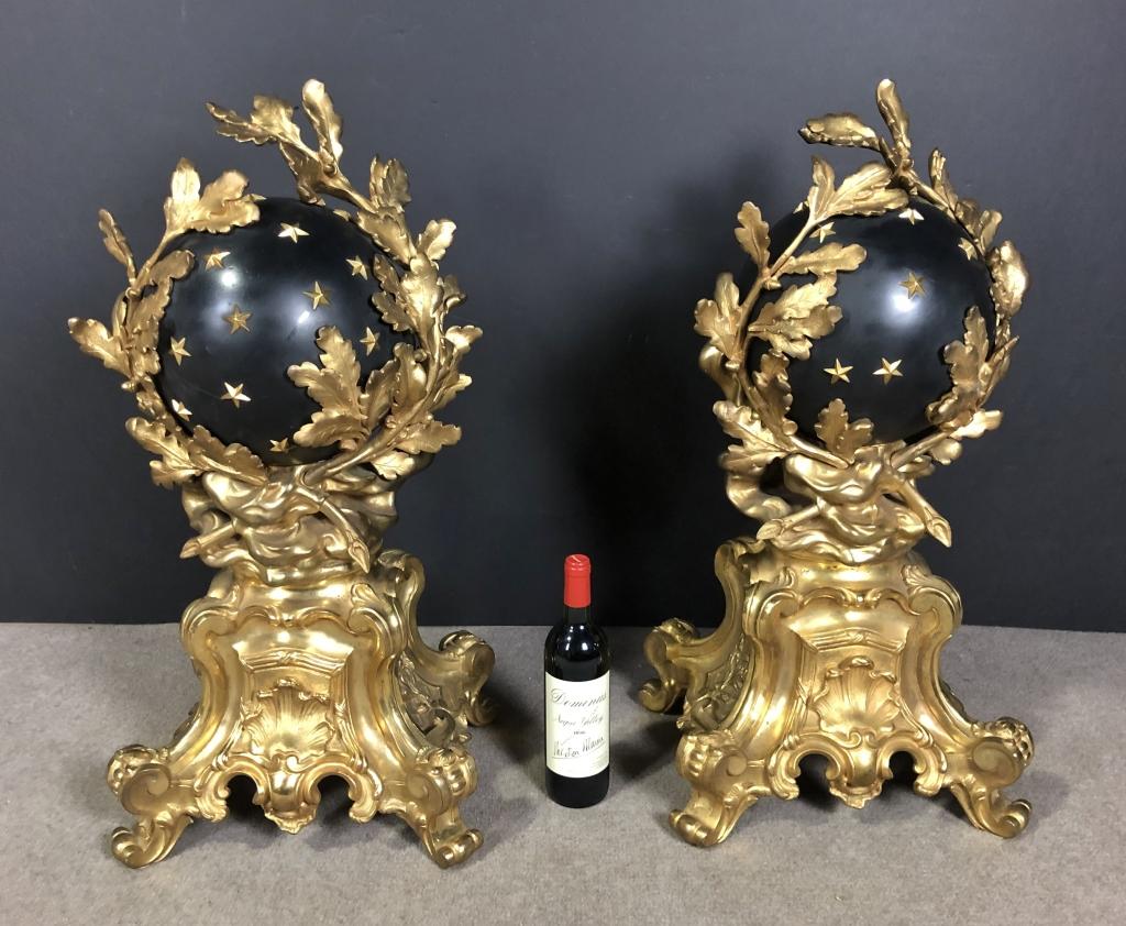 Pair of antique French Rococo style gilt and patinated monumental bronze chenets/andirons with celestial globe applied with stars and extensive gilt bronze oak leaf decoration. Of monumental size, with a Louis XV and Napoleonic influence.
One has