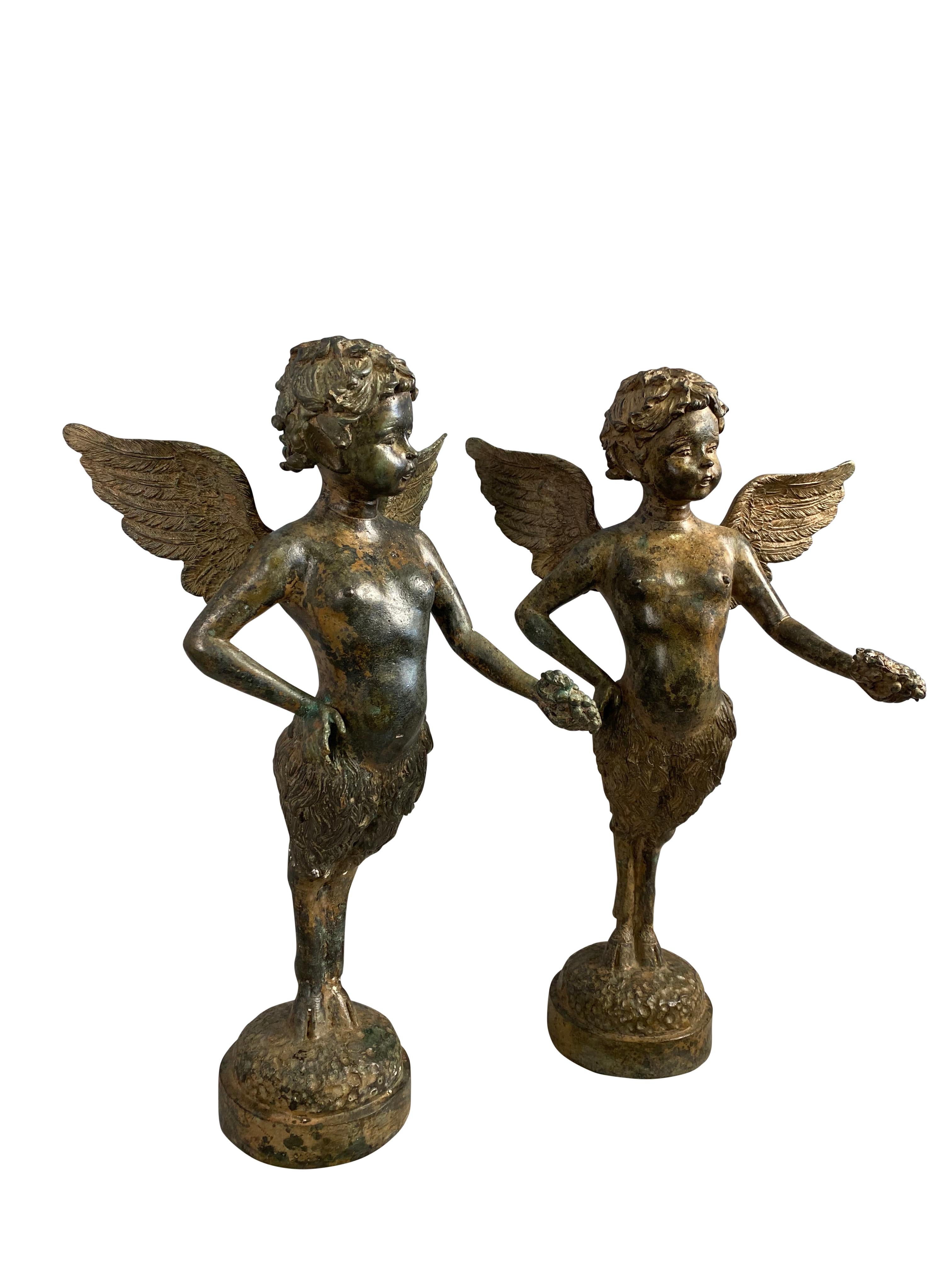 A fine pair of French bronze cherubs standing contrapposto, both extending an arm, each of which is holding a bunch of grapes.

Dimensions (cm)
40 H/20 W/10 D.