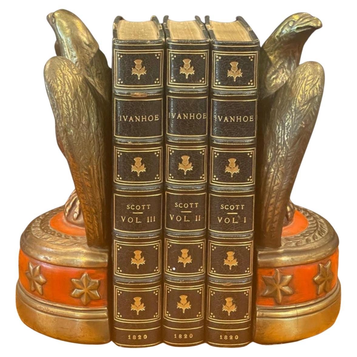 A striking pair of bronze clad American eagle bookends by Marion Bronze, circa 1960s. The eagles rest on a six star semi circle base with a red overlay and are in very good vintage condition. They measure 5.25