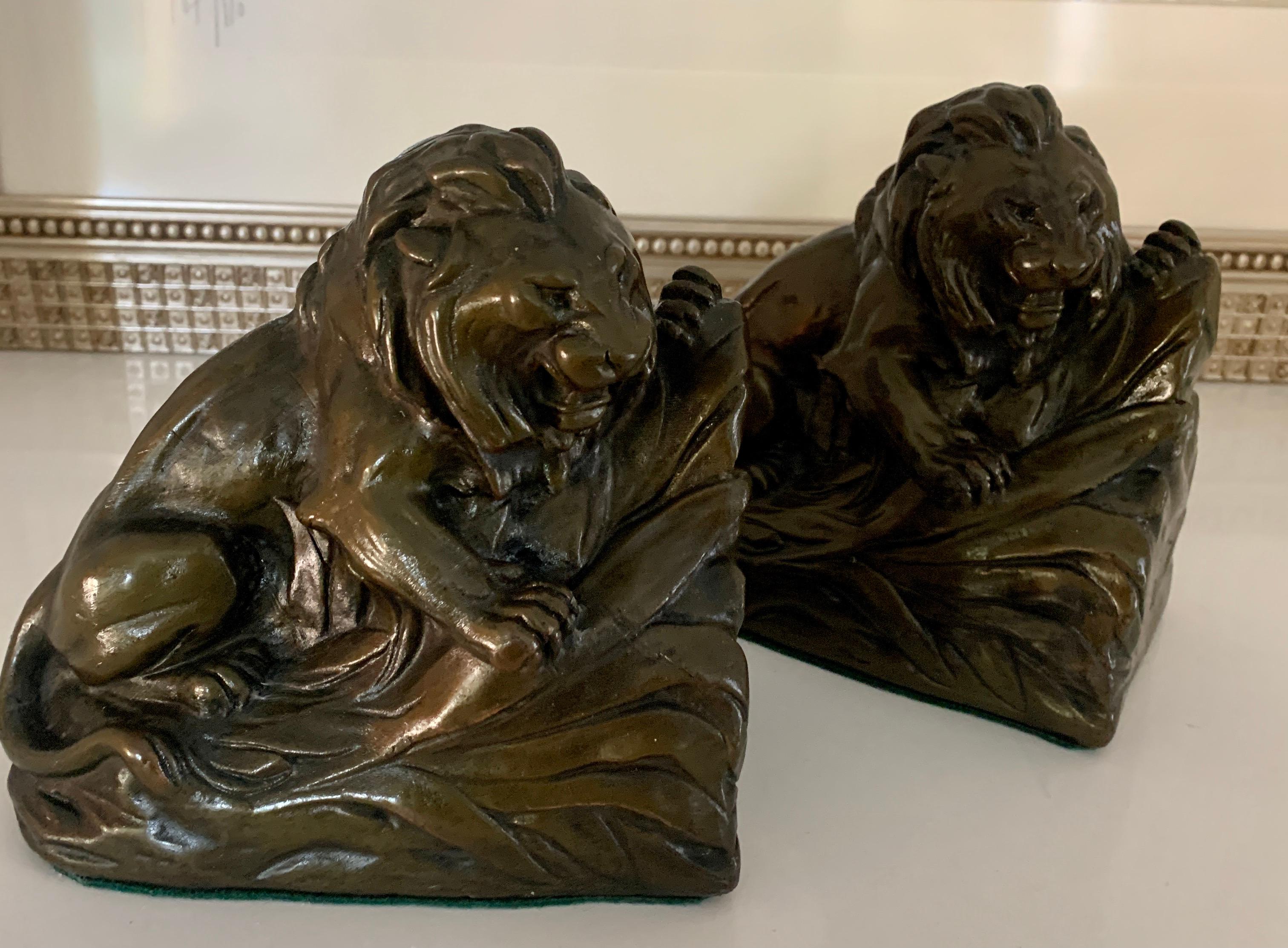 A wonderful and heavy pair of Lion bookends - clad in bronze finish, the bookends are by RUHL and a compliment to any desk or bookshelf.