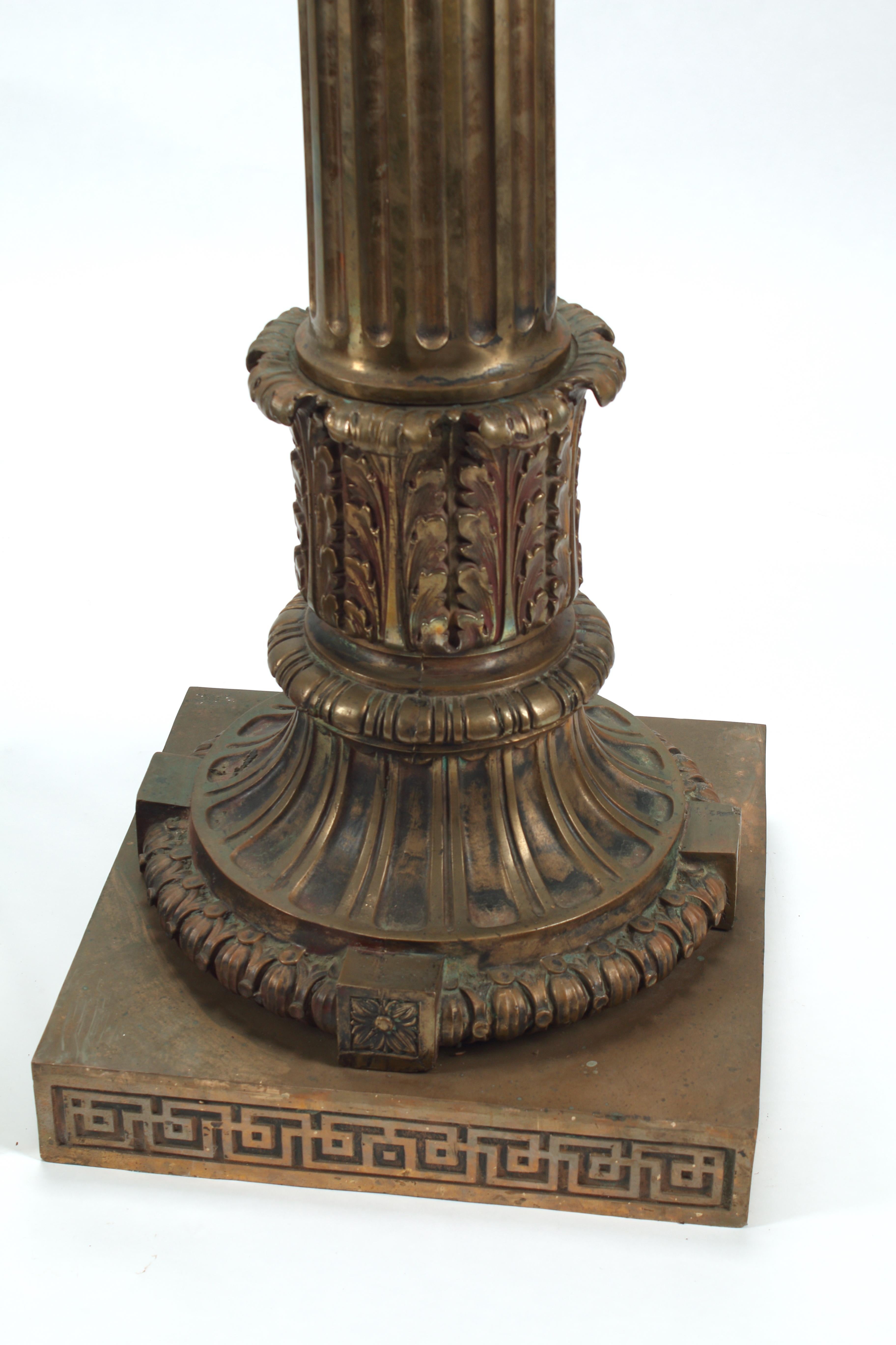 This pair of monumental bronze Corinthian style columns, crafted circa 1900 in New York, evoke the grandeur of turn of the century architecture. The capitals of the columns are in the Corinthian style with intricate acanthus leaves that delicately