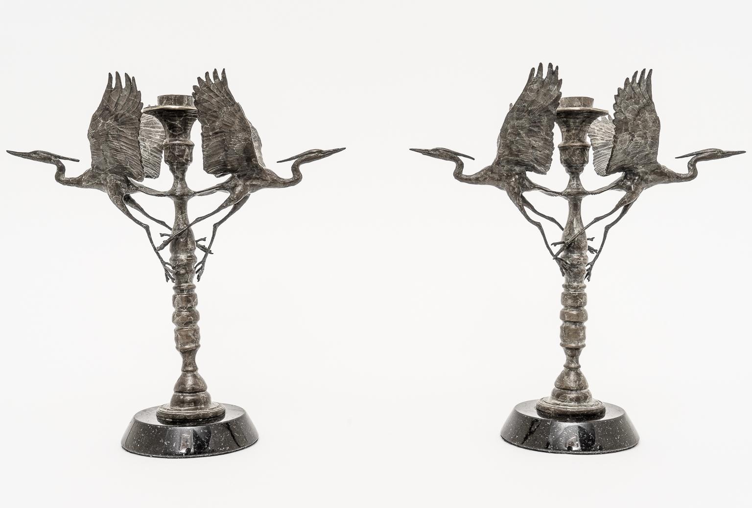 Artisan Ltd Edition bronze crane motif candleholders Signed Dm 97 AM 7/200 and AM 8/200. - a pair. In normal light these are somewhat dark but we super-flooded with light to show details.

Note: Signed AM 7/200 and AM 8/200.
