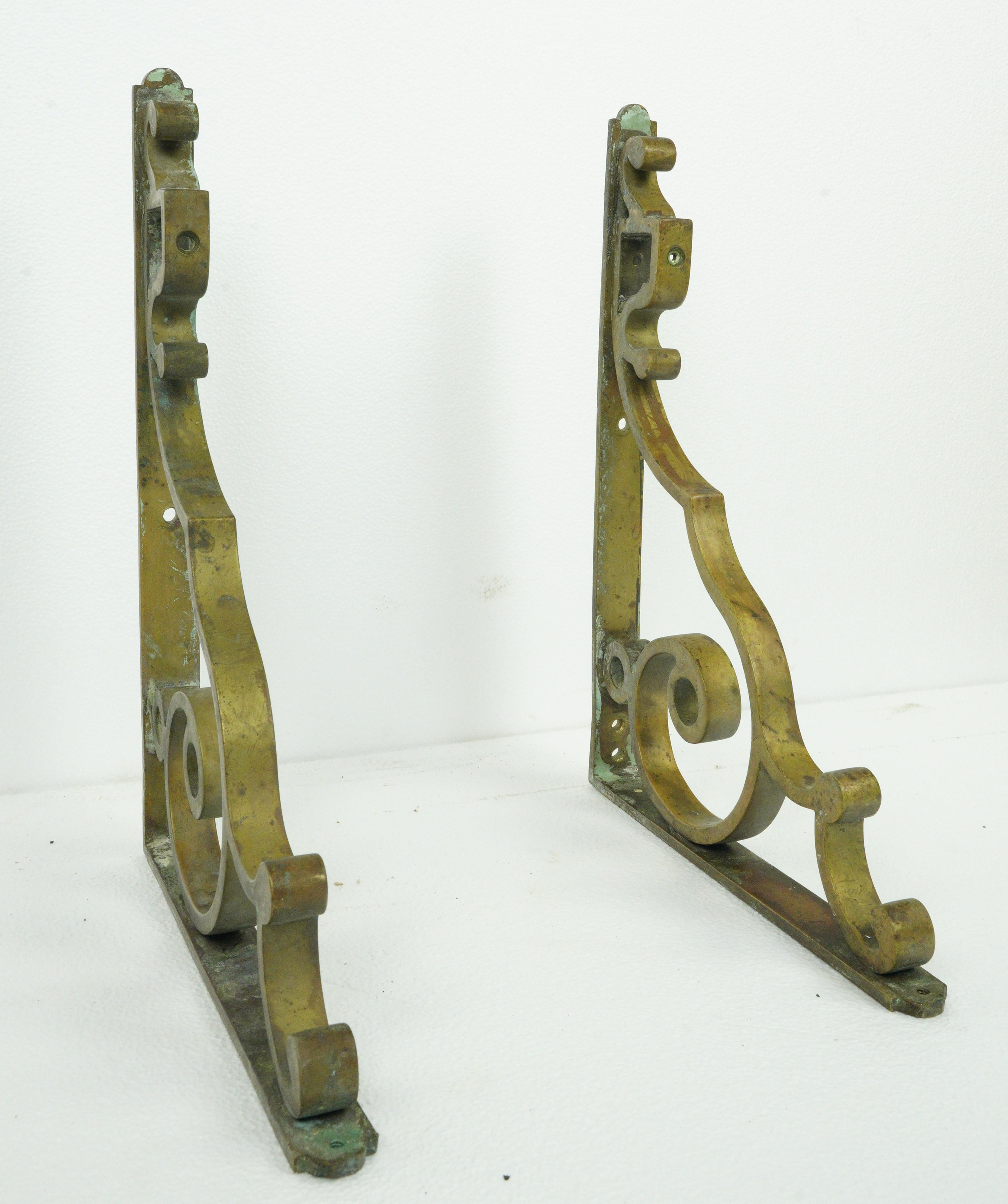Solid bronze shelf brackets with curled details. Good condition with appropriate wear from age, with patina and minor scratches. Priced as a pair. Please note, this item is located in our Scranton, PA location.