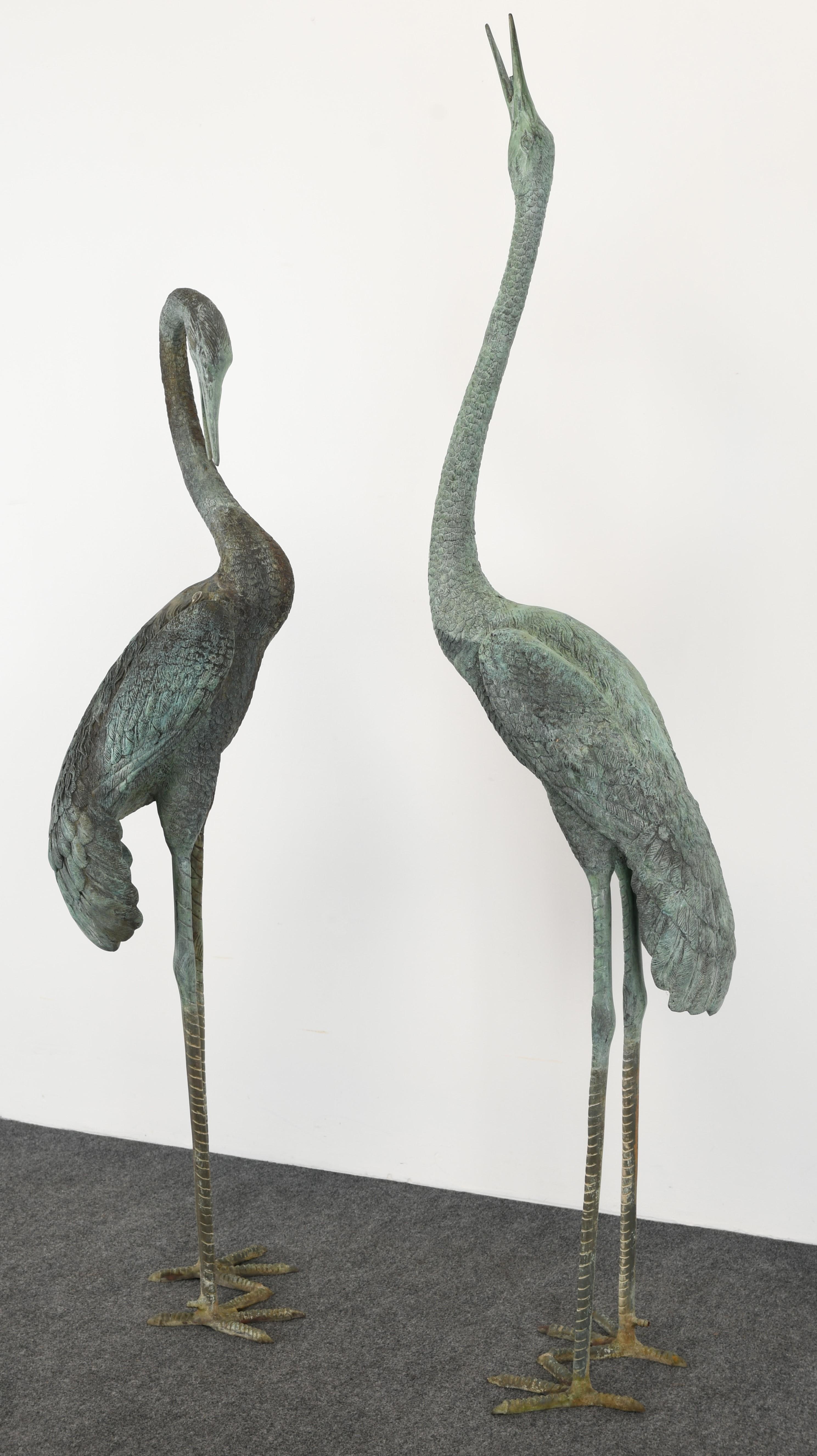 A monumental pair of Egret or Crane Fountains. This stylish pair would be stunning in a garden setting. The bronze egrets are highly detailed and each has a fountain spout, as shown in images. They are structurally sound and in good condition with