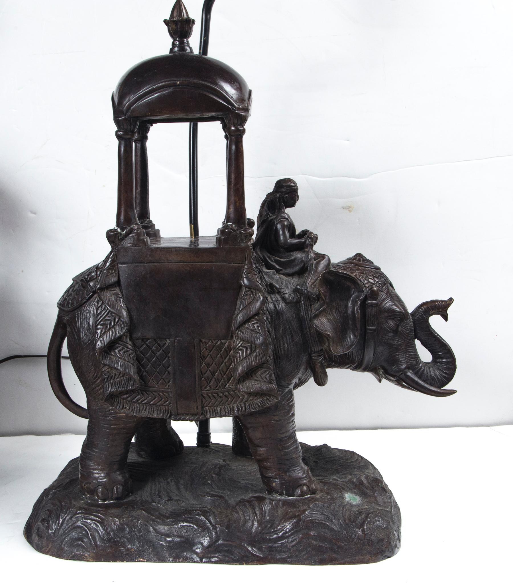 Very well cast bronze lamps. The elephant stands upon natural integral base . Traditional draping to the elephants' back and heads'
A mahoot sits on the neck of the elephants holding reigns. A howdah of 4 columns and a domed area topped by a finial,