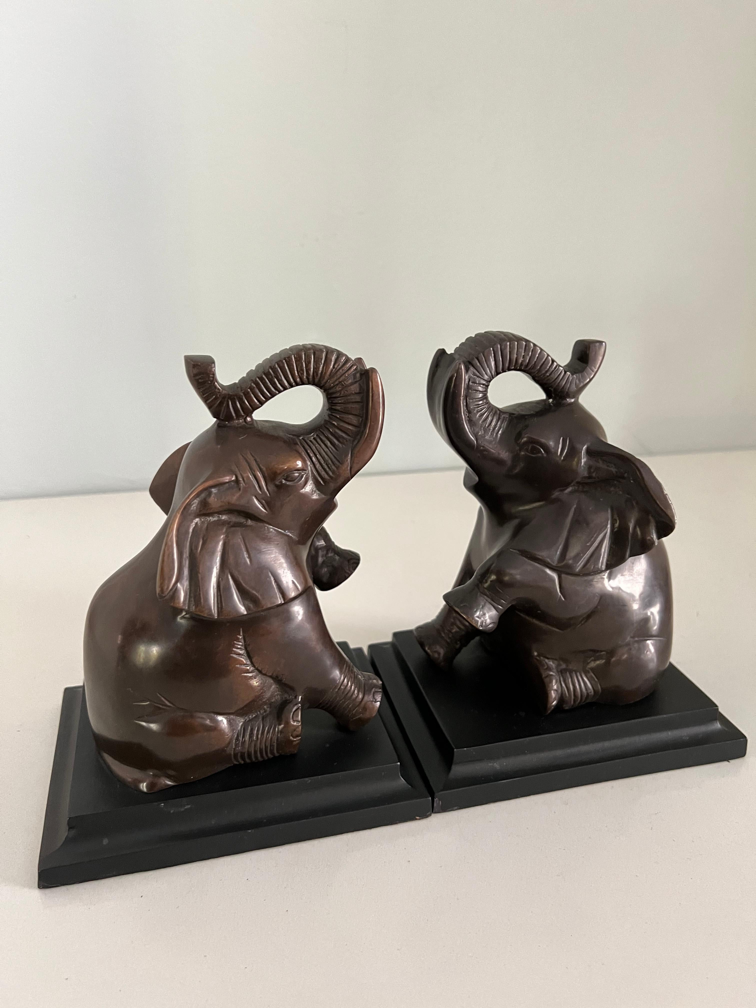 Pair of elephant bookends with felted bottom. A complement to any bookshelf, particularly nice in a children's bedroom. 

