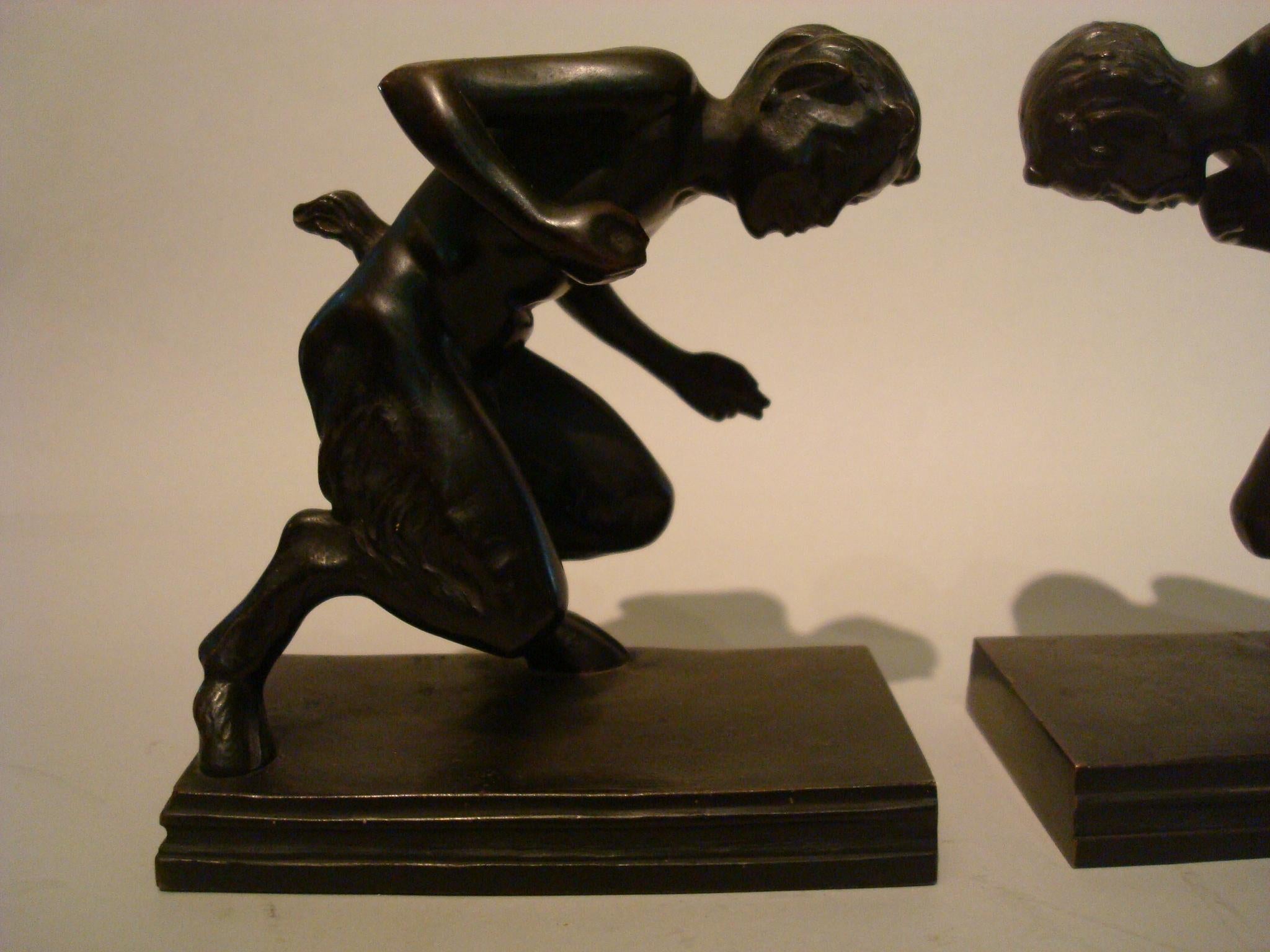 Pair of bronze Faun figures bookends, Austrian, early 20th century, attractive patina, one stamped with a very small triangular foundry mark. Very nice pair of sculptures.