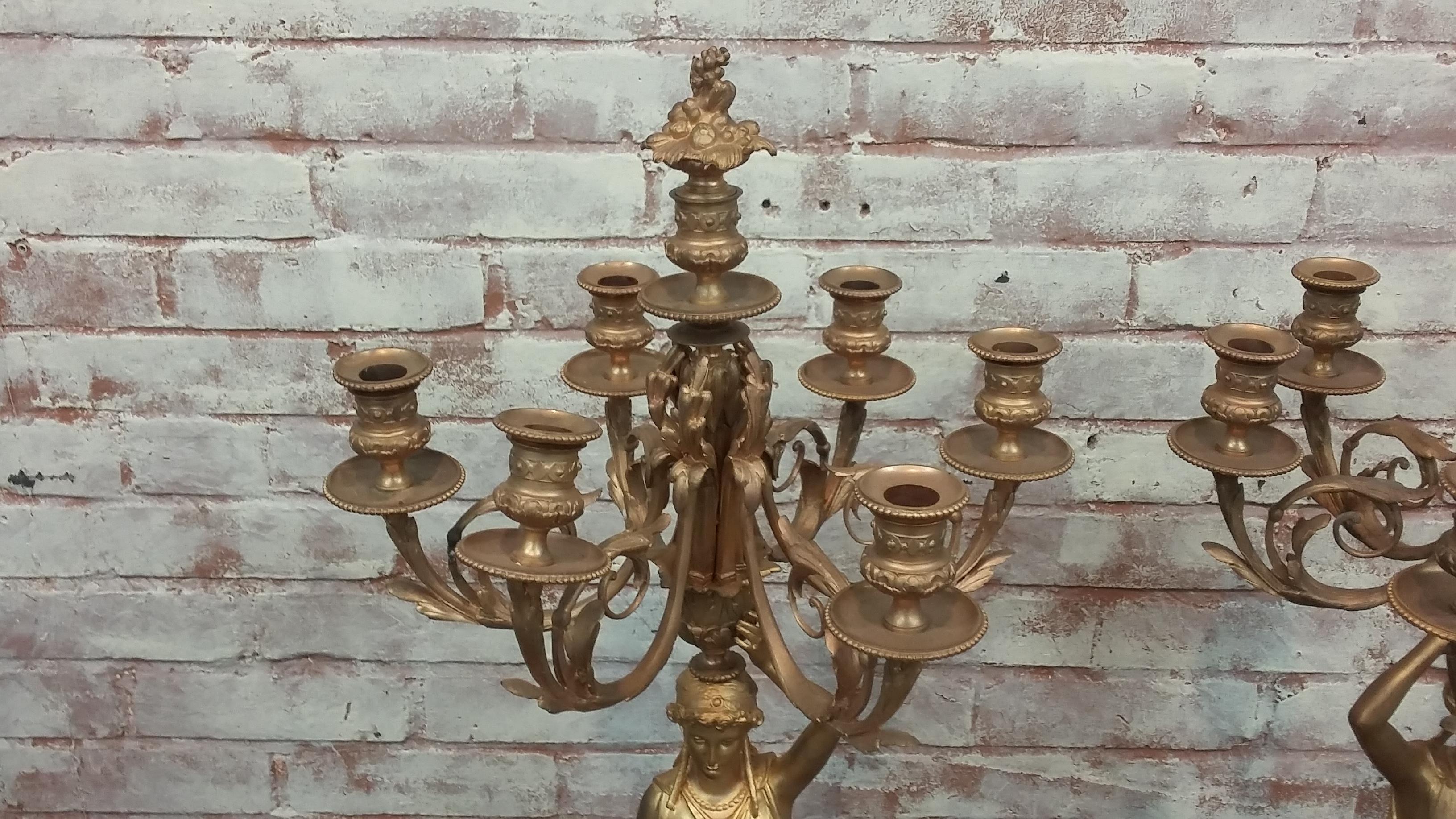 Pair of 20th century fine crafted bronze candelabras. Figural design in a gold painted finish. Two similar women (left and right) with six candle arms each as well as a candleholder at the very top.