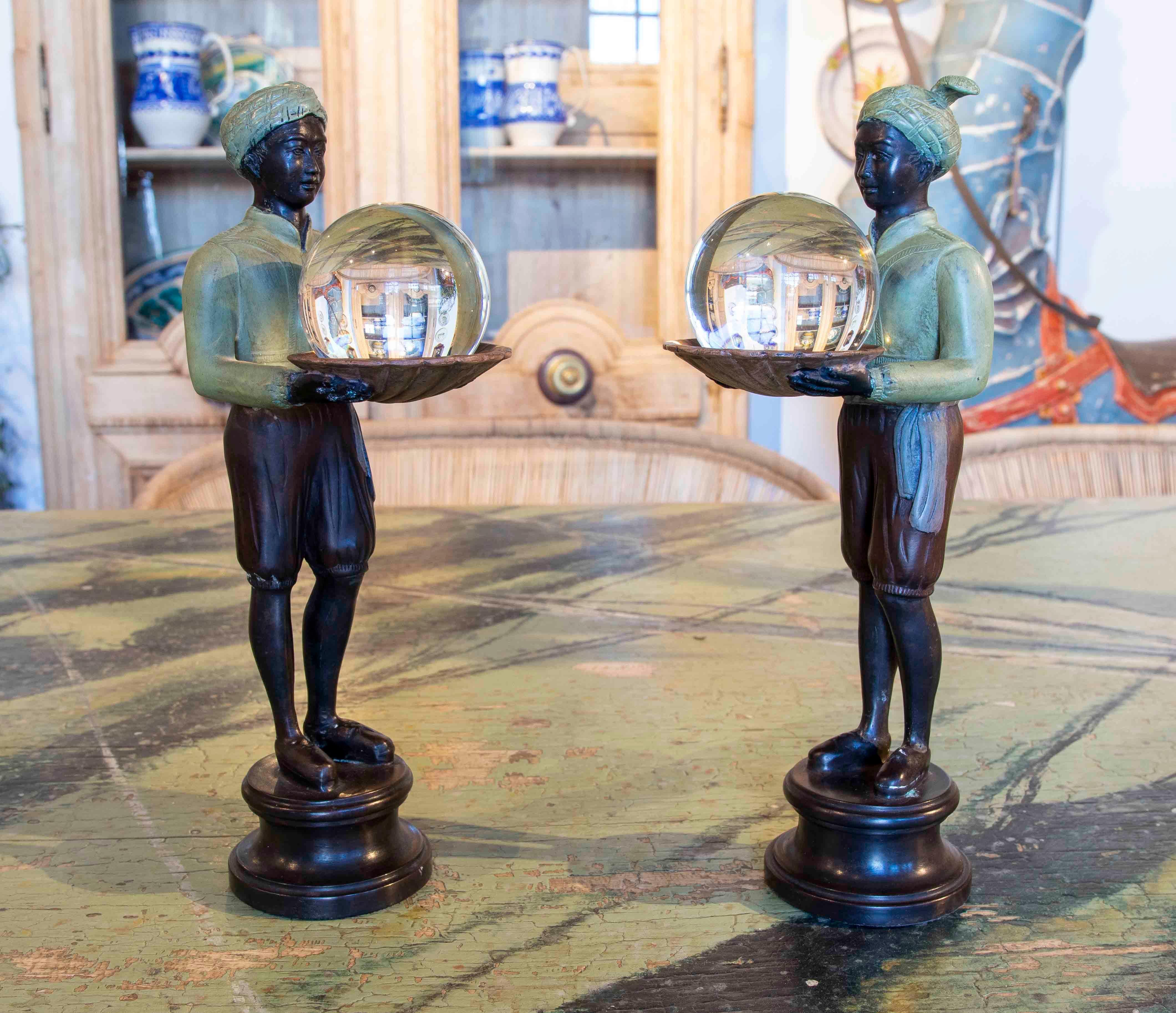 Pair of bronze figurines of characters with tray and crystal ball.