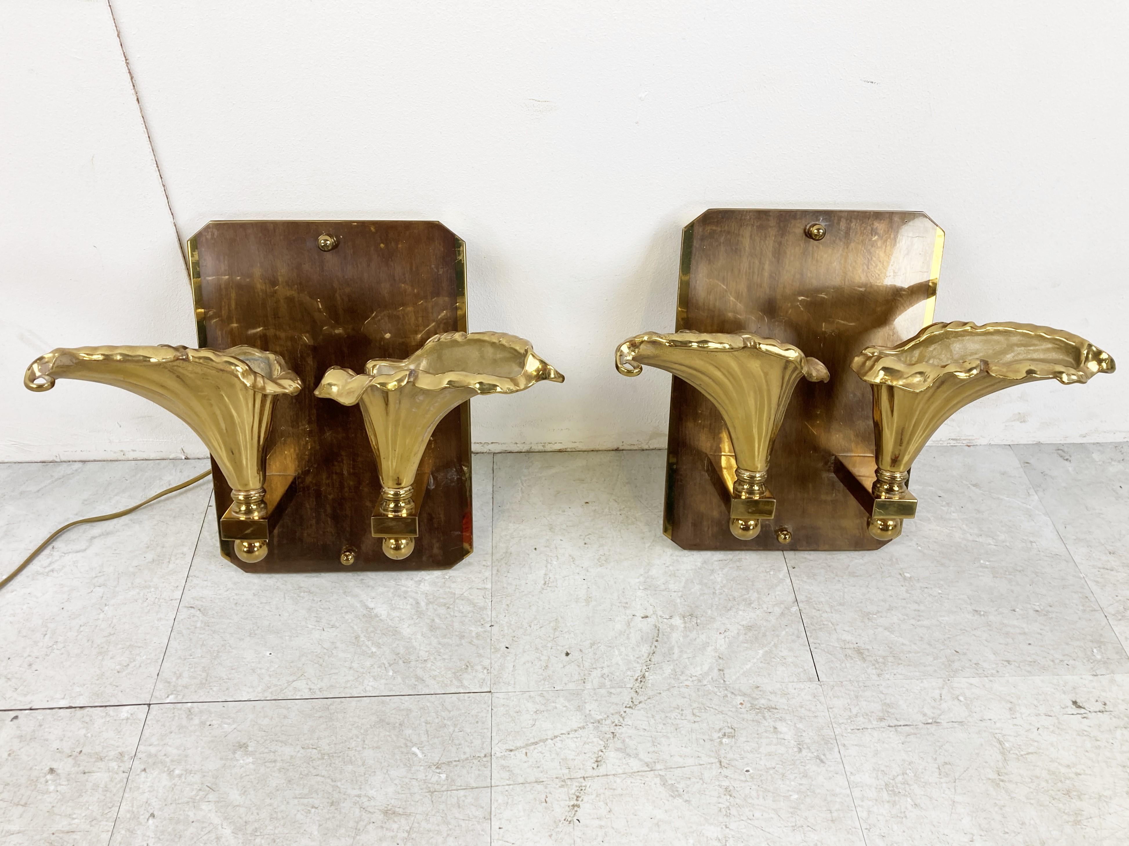 Pair of heavy bronze double flower wall lamps.

The spectacular wall sconces where made in belgium and are beautifully made.

1970s - Belgium

Good condition, tested and ready to use 

Work with GU 10 spots 

Dimension:
Height: