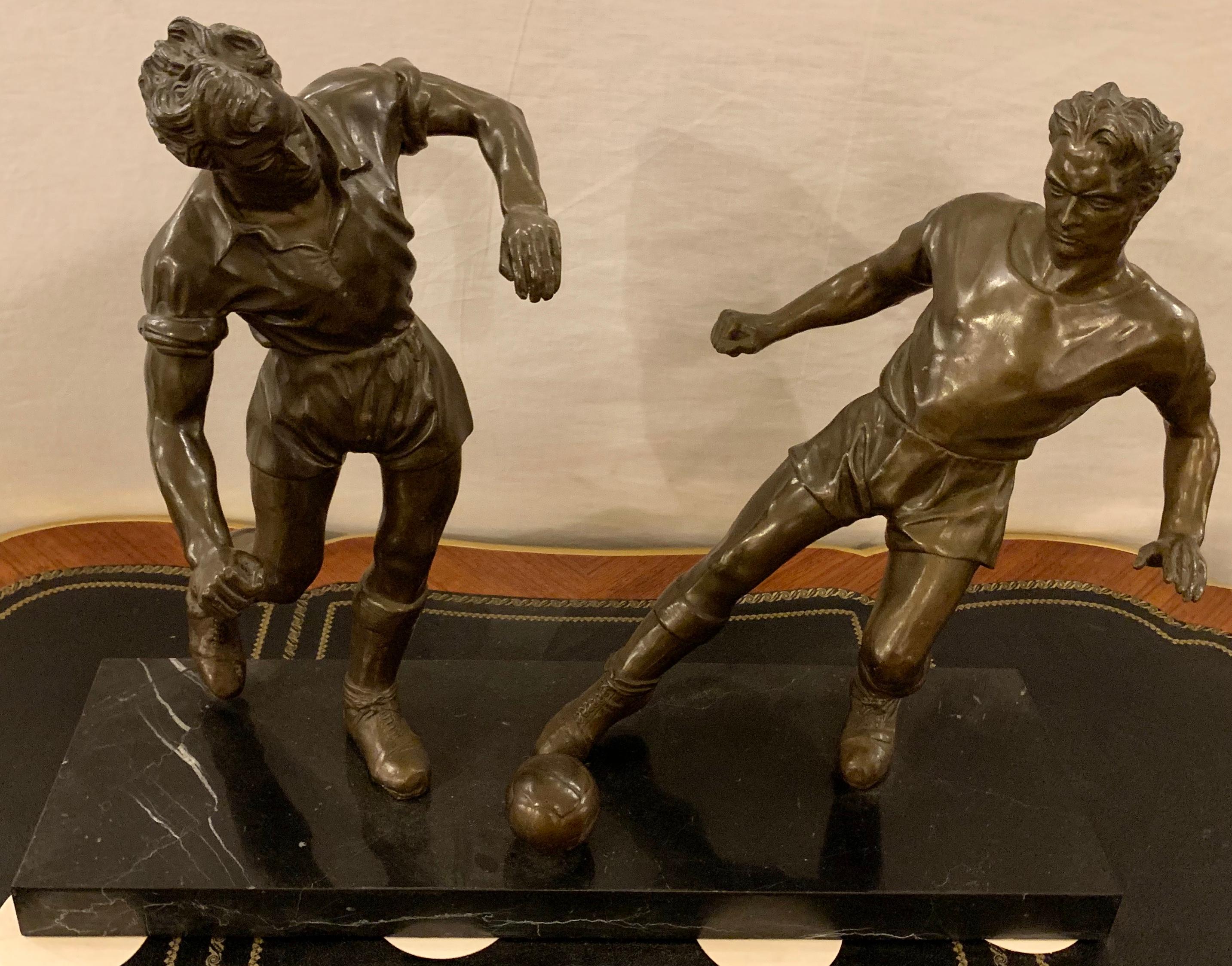 Pair of bronze football or soccer players on a black and white veined marble slab.

Greg
1SXX/11XA.