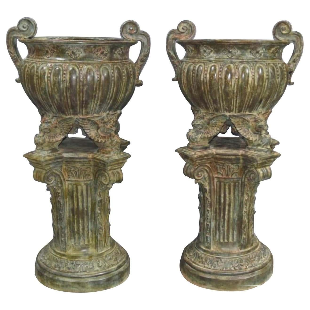 A stunning pair of French Empire style garden urns in bronze, 20th century. Amazing architectural pair, can you imagine these in your garden overflowing with flowers. Stand in at nearly five feet tall so good size. Lovely Verdigris patina and