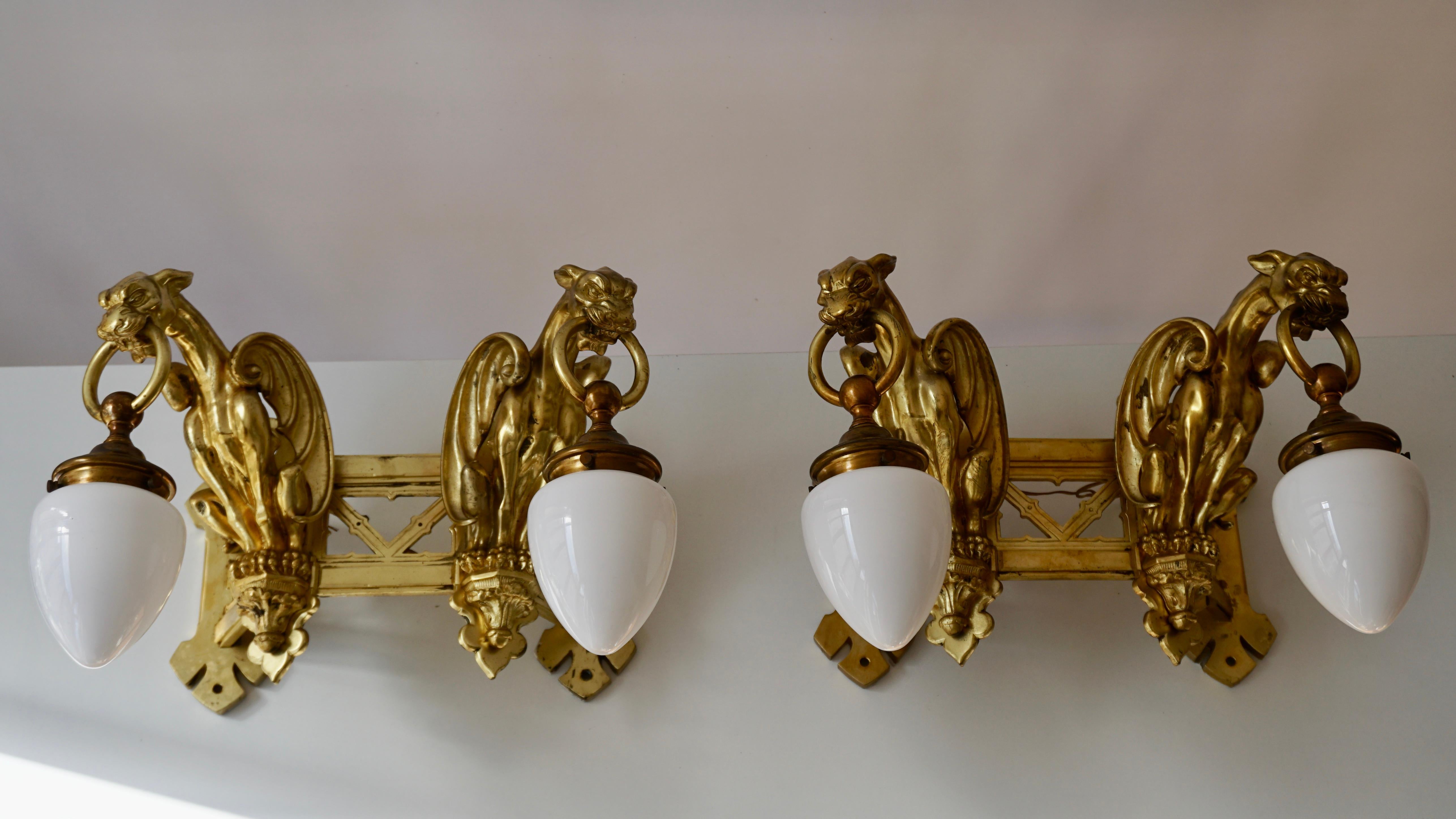 Hollywood Regency Pair of Bronze Gilt Wall Sconces Representing Two Griffins For Sale