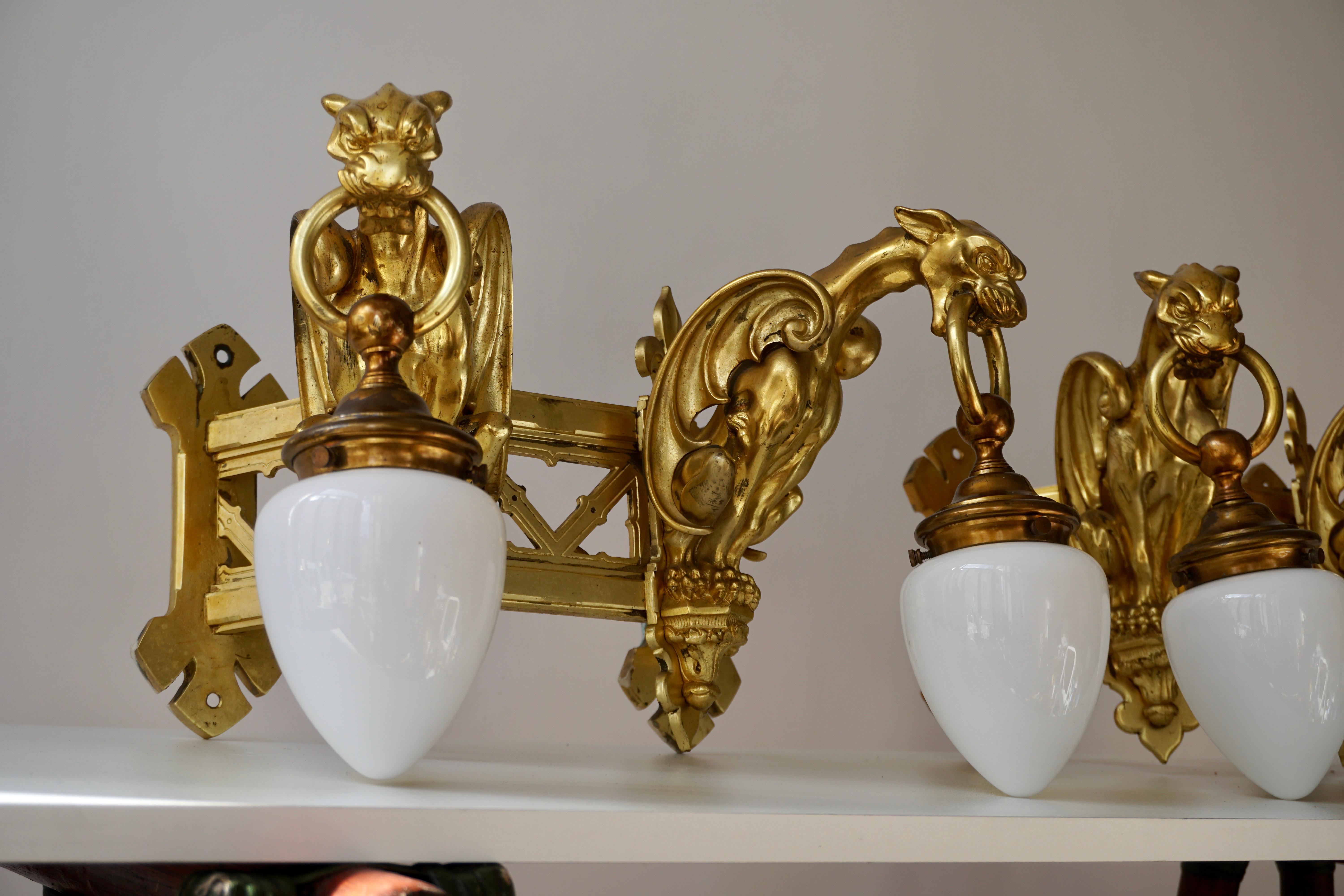 Italian Pair of Bronze Gilt Wall Sconces Representing Two Griffins For Sale
