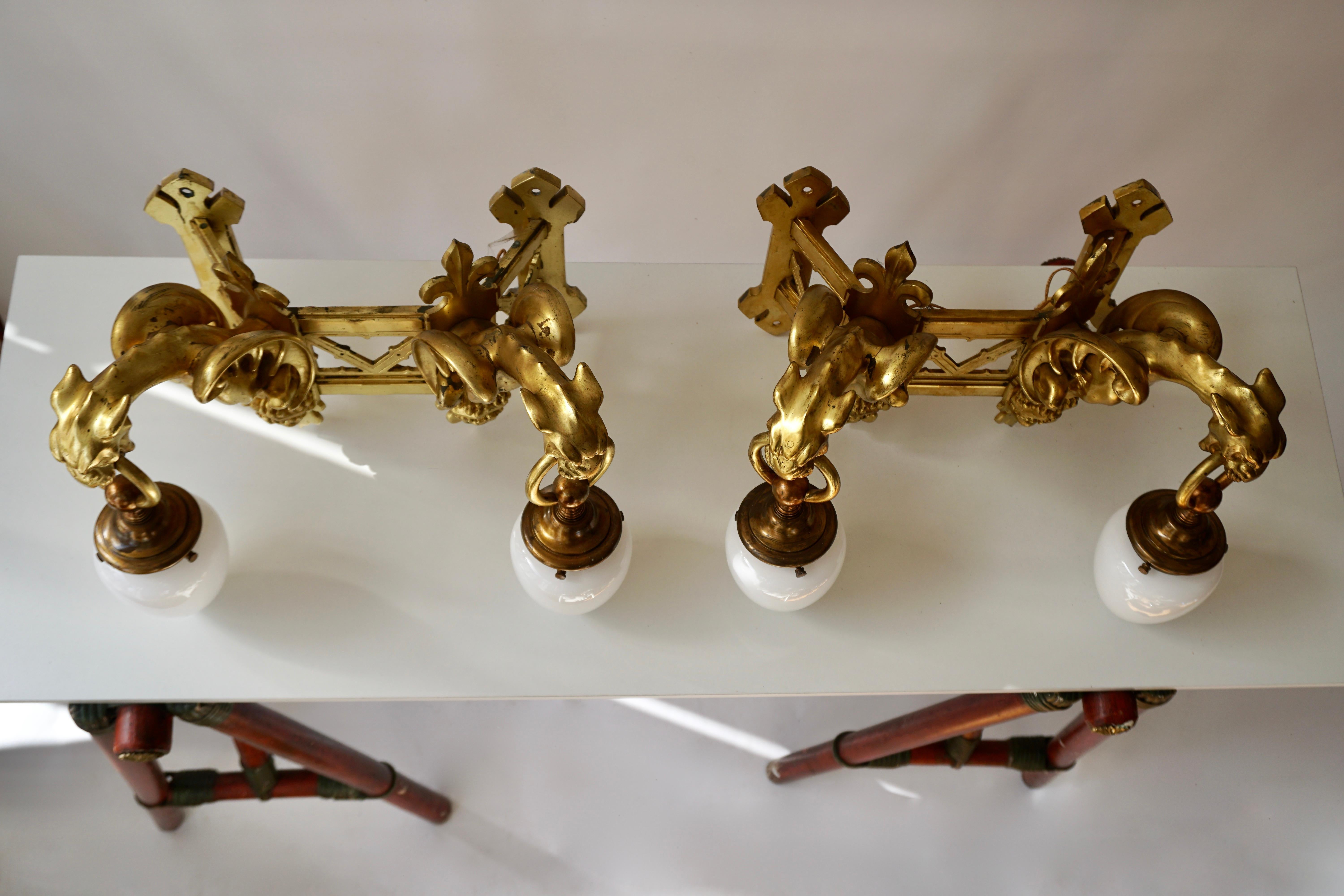 Opaline Glass Pair of Bronze Gilt Wall Sconces Representing Two Griffins For Sale