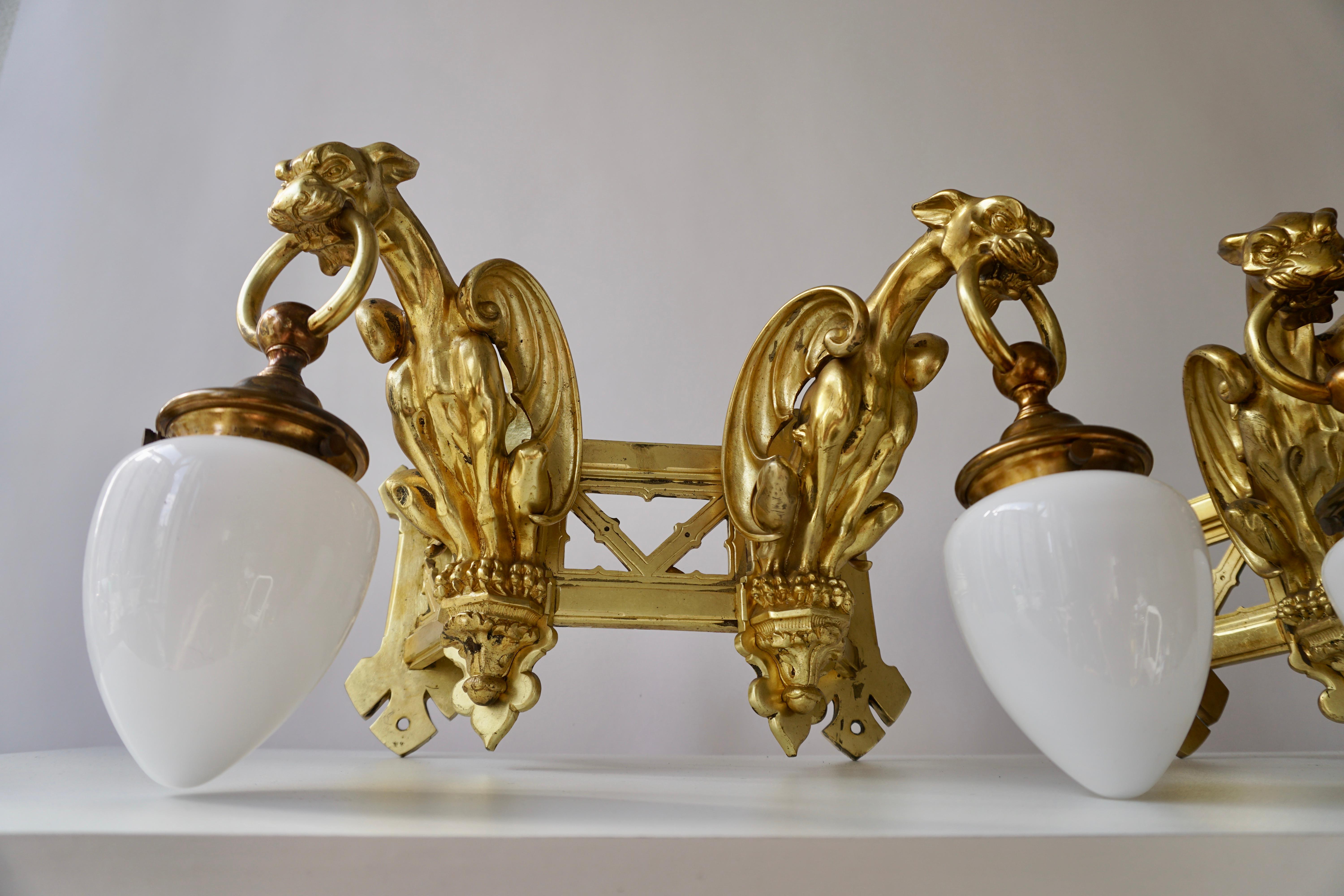Pareja de apliques de bronce dorado que representan dos grifos en venta 1