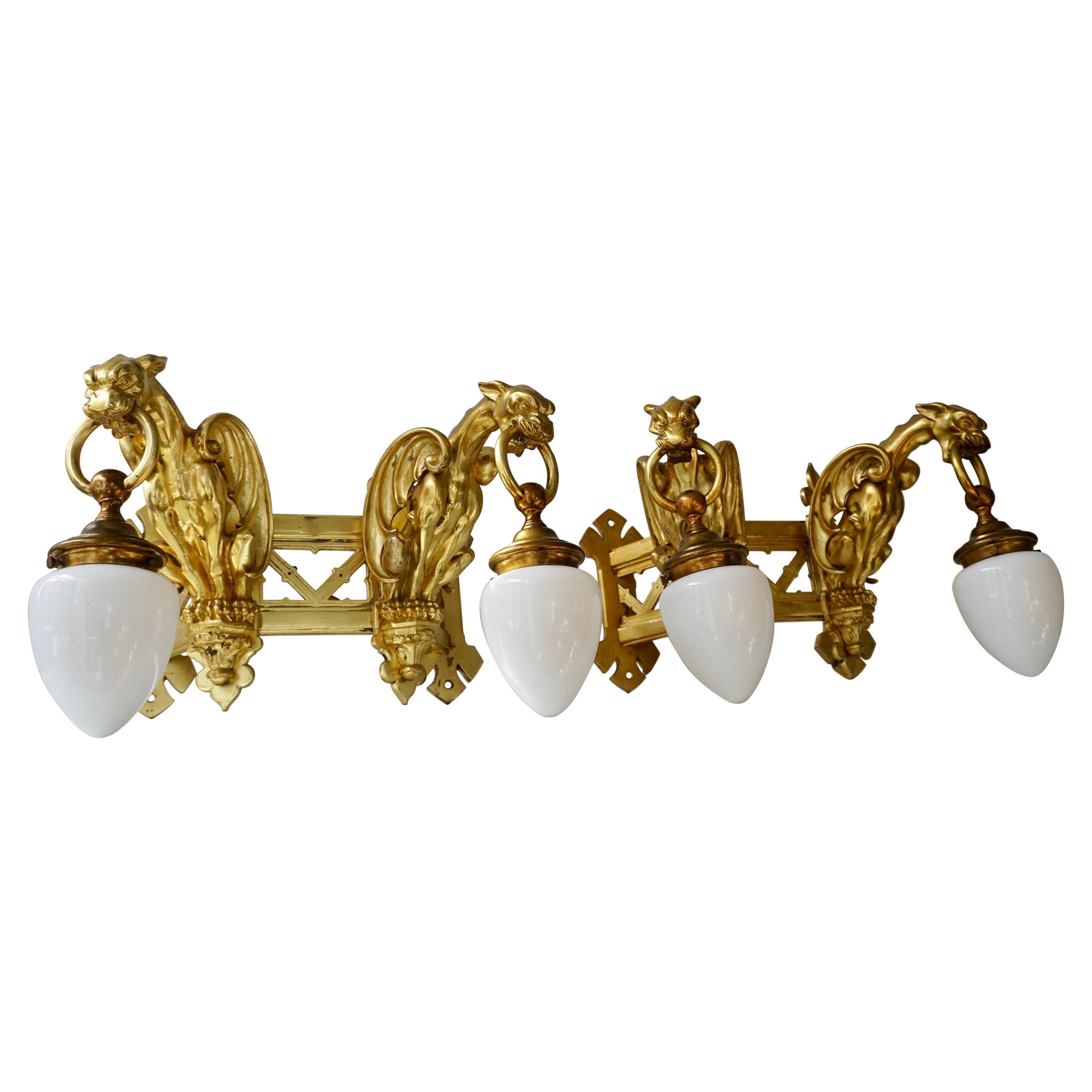 Pair of Bronze Gilt Wall Sconces Representing Two Griffins For Sale