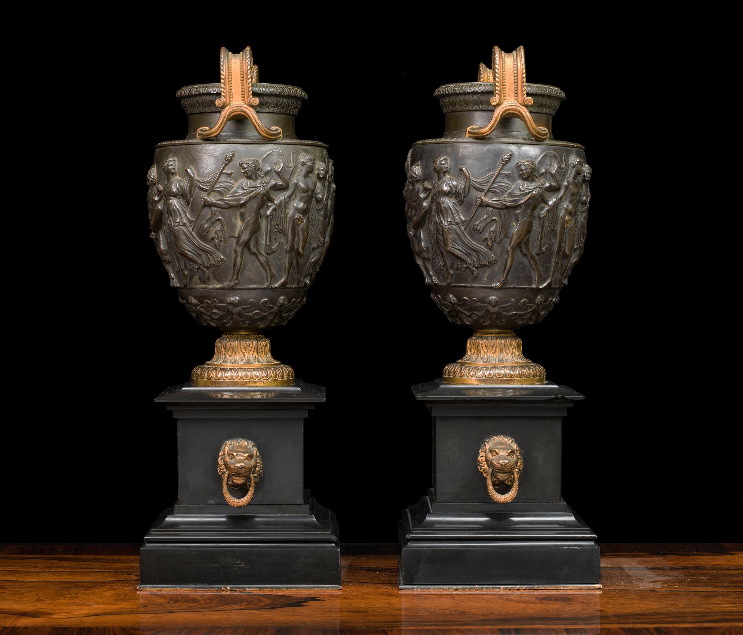 A very fine pair of bronze vases, taking the form of the Townley Vase. The vases are modelled on a krater, a Greek vessel used for mixing water and wine. Each vase has elegantly scrolling bifurcated gilt handles, and the body of the vases are cast
