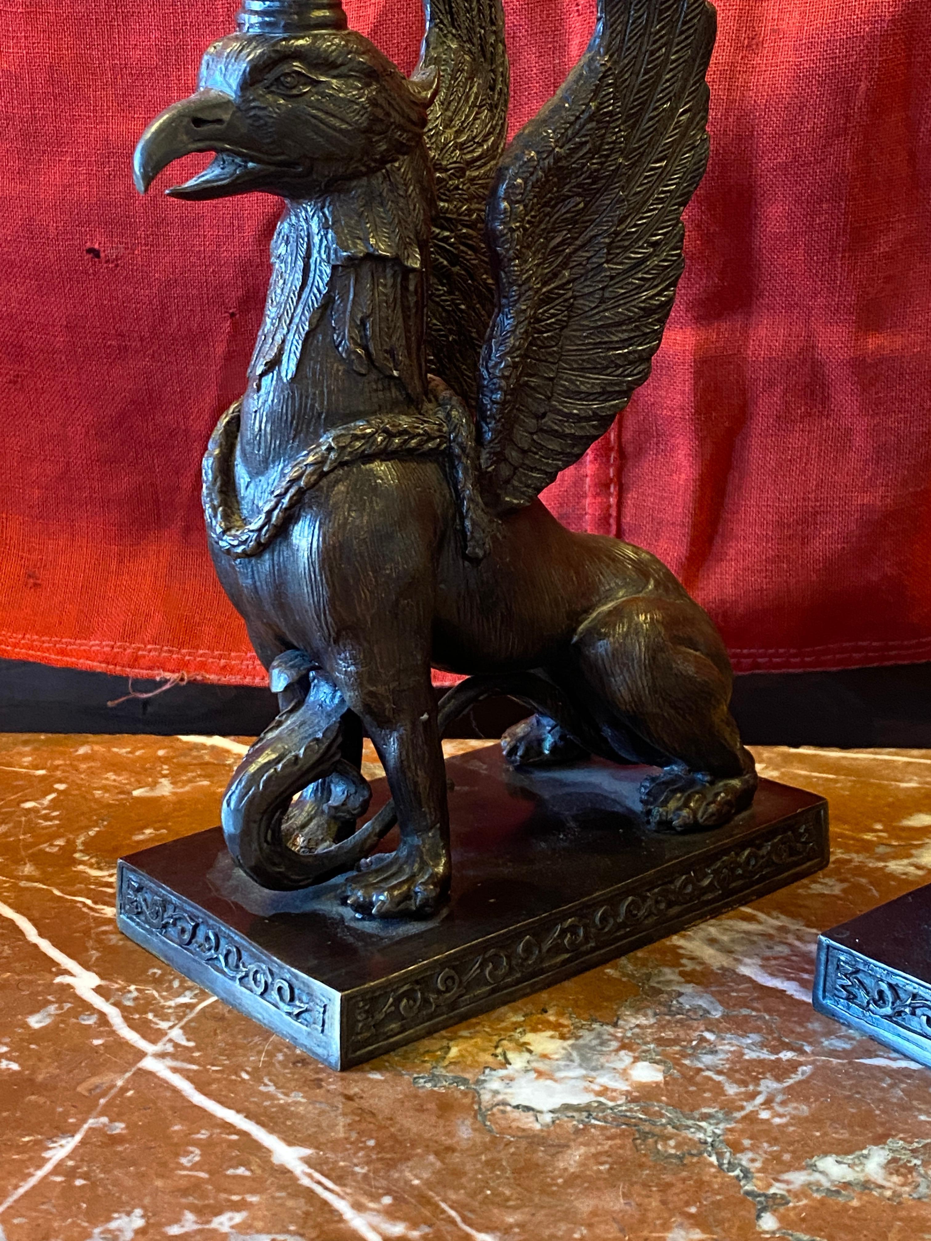 Neo-Classical style Griffin form candle holders in bronze. 
Measures: 10.5