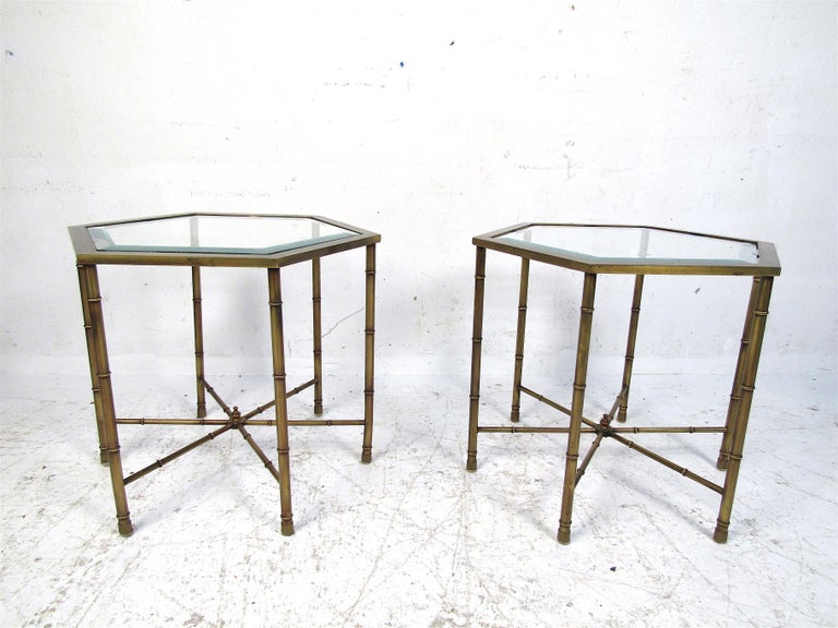 This pair of midcentury end tables are perfect for any living room or office space. The well-aged bronze base has loads of character, and help to make this set truly one of a kind. Clean glass tops complete the aesthetic. Please confirm the location