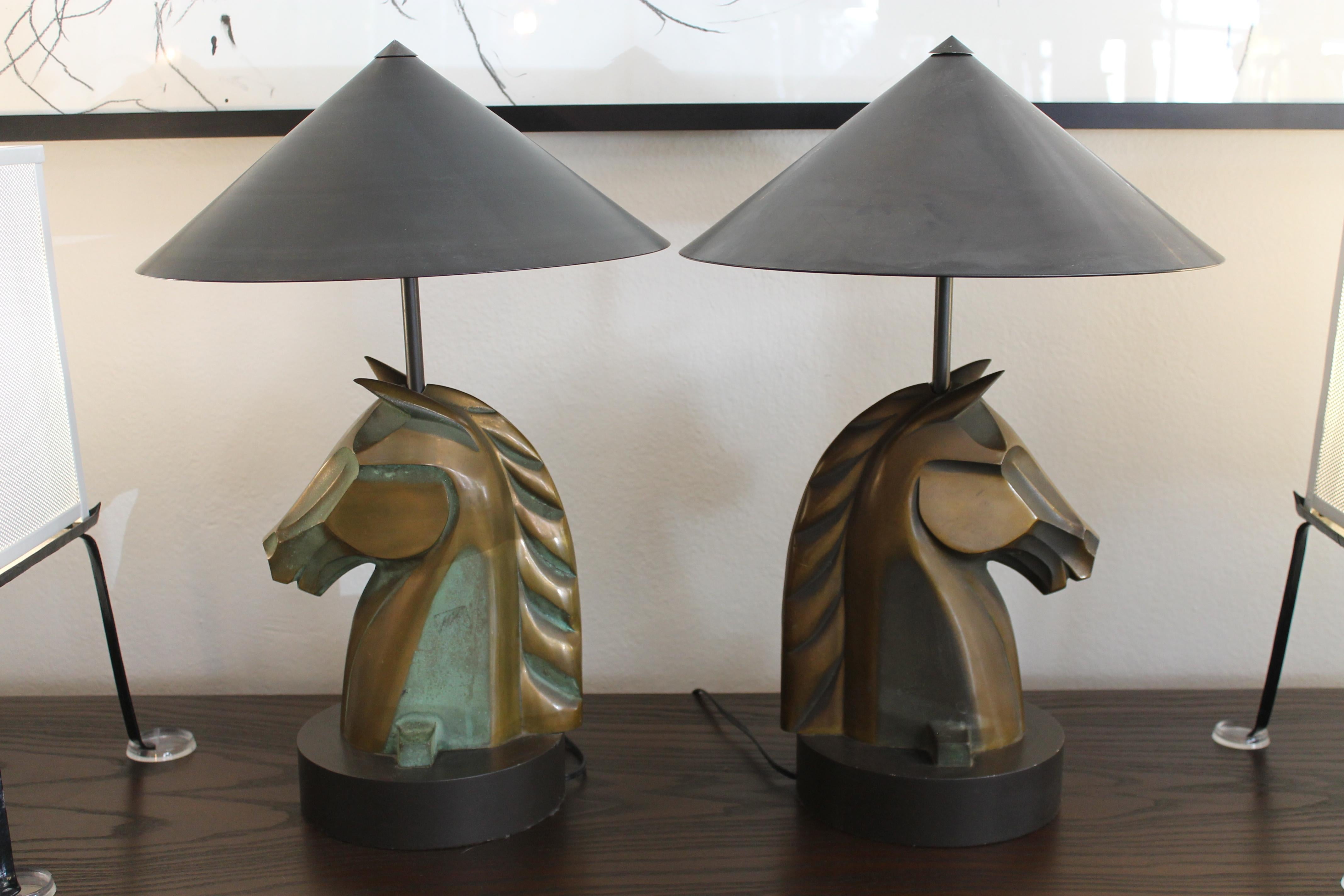 Pair of bronze horse head lamps on black steel bases. Base is 8