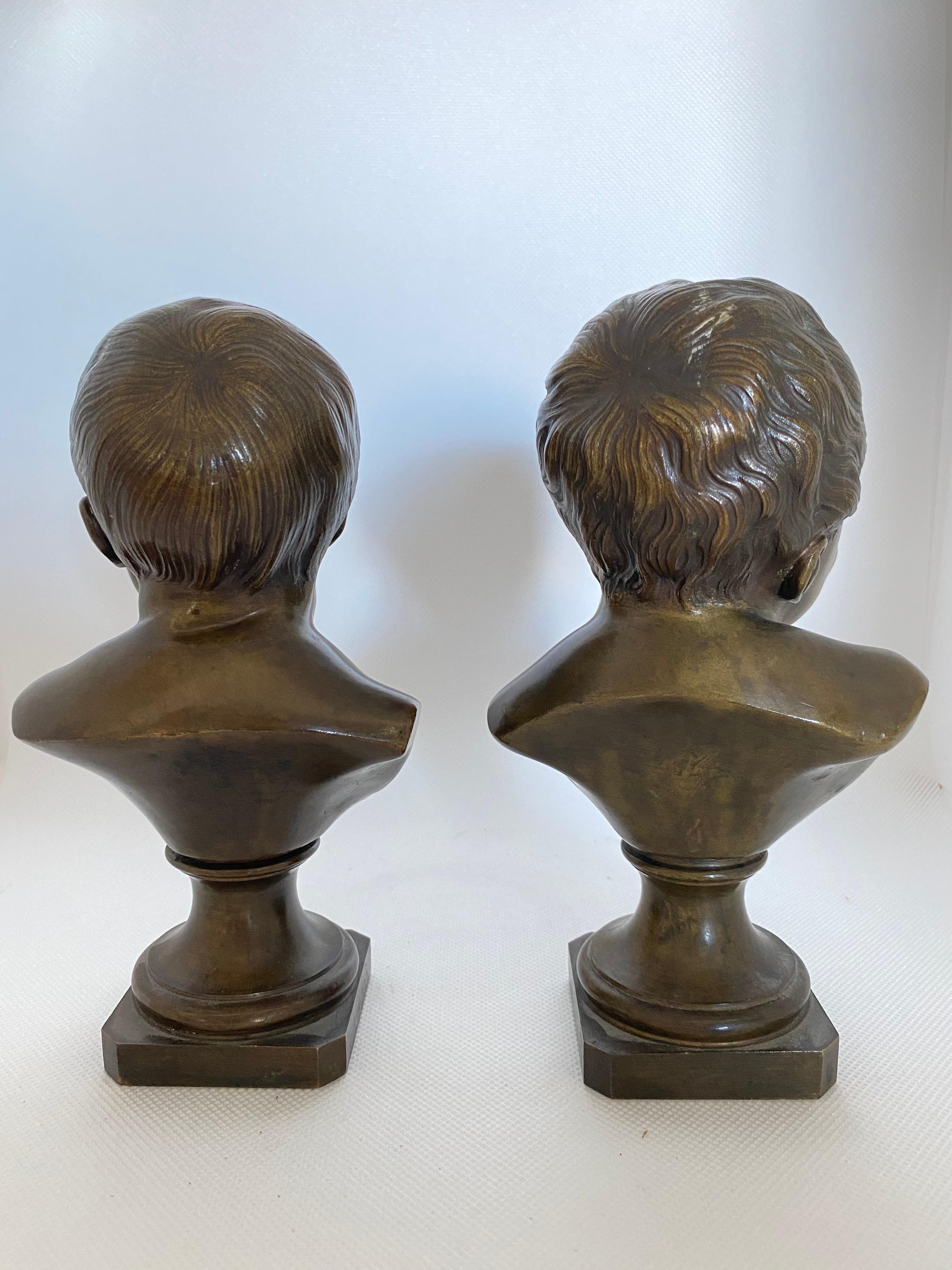 A charming pair of patinated bronze infants cast in the 19th century. One of the babies is happy, while the other one is crying, perhaps corresponding to an 18th century poem by Votaire. 