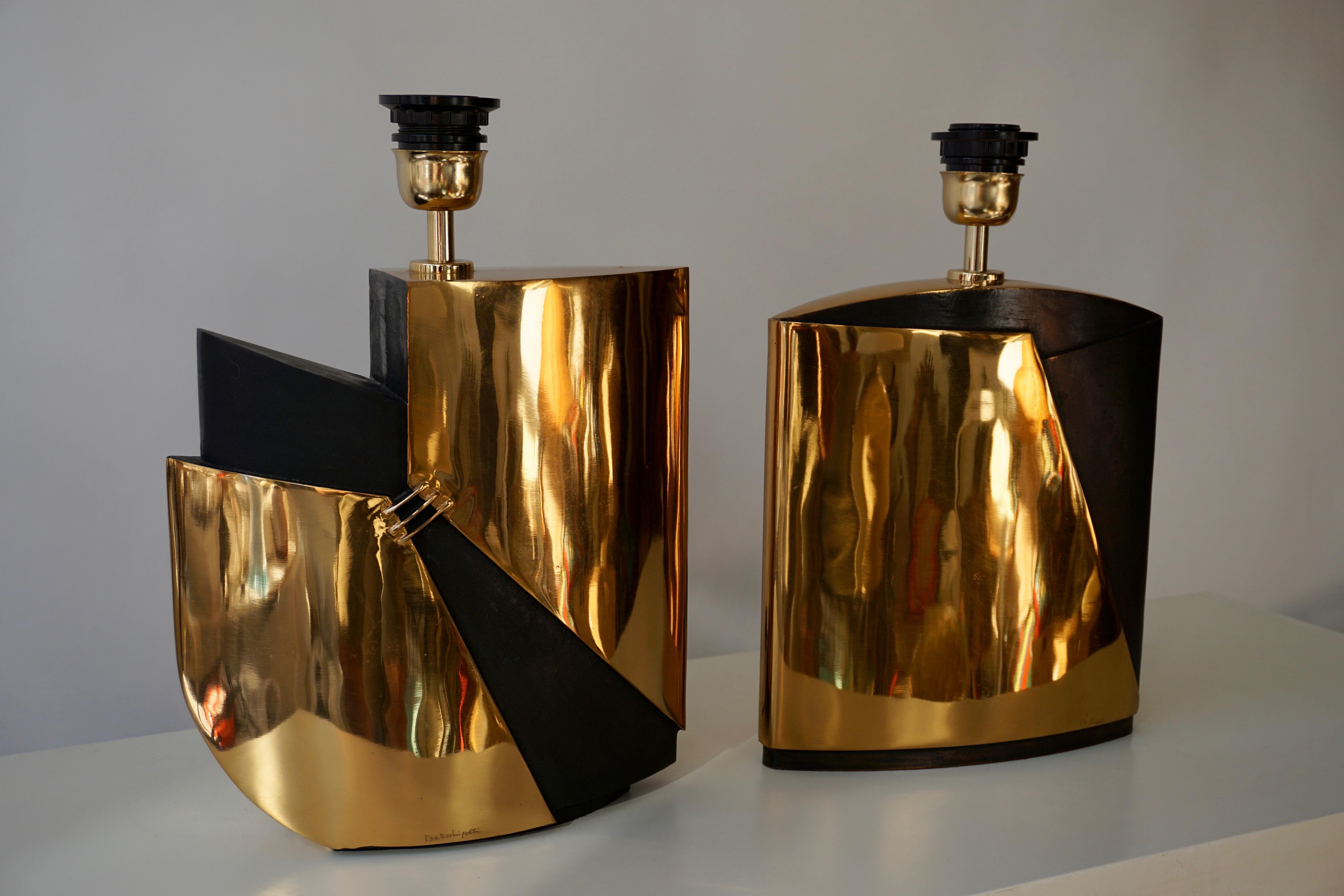 Two bronze double patina table lamps signed by Esa Fedrigolli.Italy 1970s.
Shades are not provided. 
Dimensions are given without shade.
Measures: 
Height 28 cm, width 26 cm, depth 10 cm.
Height 27 cm, width 24 cm, depth 7 cm.
 