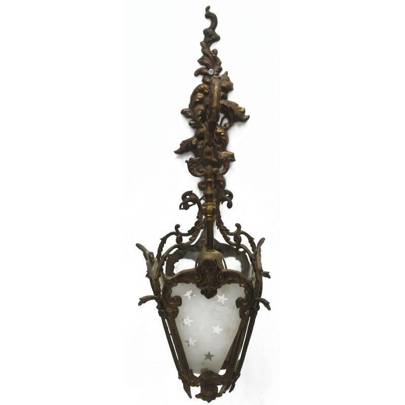 Pair of early 20th century bronze lantern sconces in the Louis XV style, height dimension with 60 cm chain for a width of 20 cm and a depth of 30 cm.

Additional information: 
Material: Copper & brass, metal & wrought iron, glass & crystal.