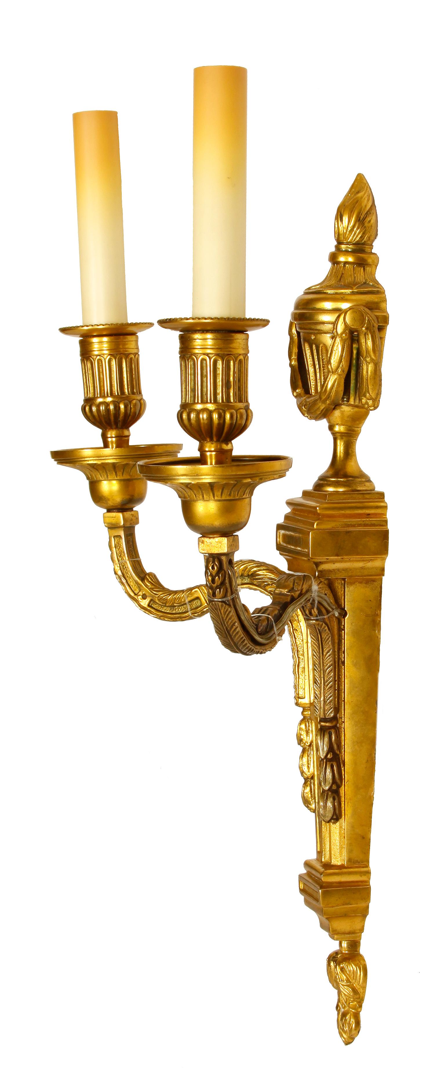 Pair of bronze Louis XVI style sconces with urns and garland motif.