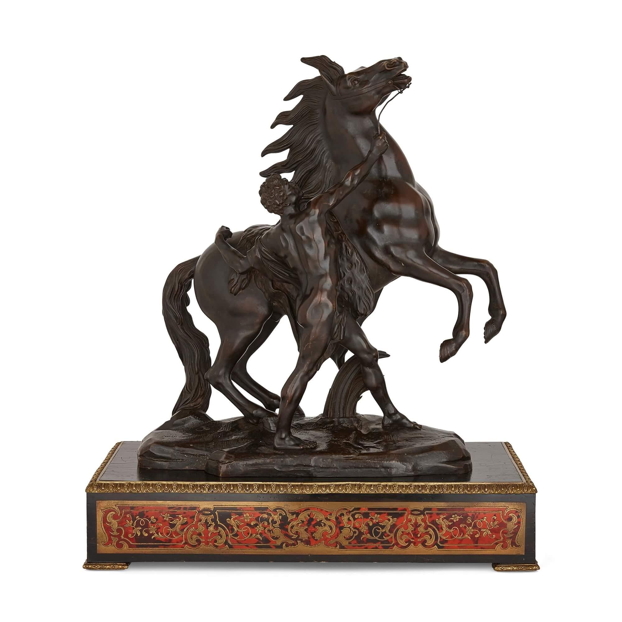 Pair of bronze Marly horses on Boulle style marquetry stands
French, late 19th century
Measures: Total height 73cm
Horses: Height 60cm, width 53cm, depth 23cm
Plinths: Height 13cm, width 63cm, depth 34cm

The bronzes in this pair are after