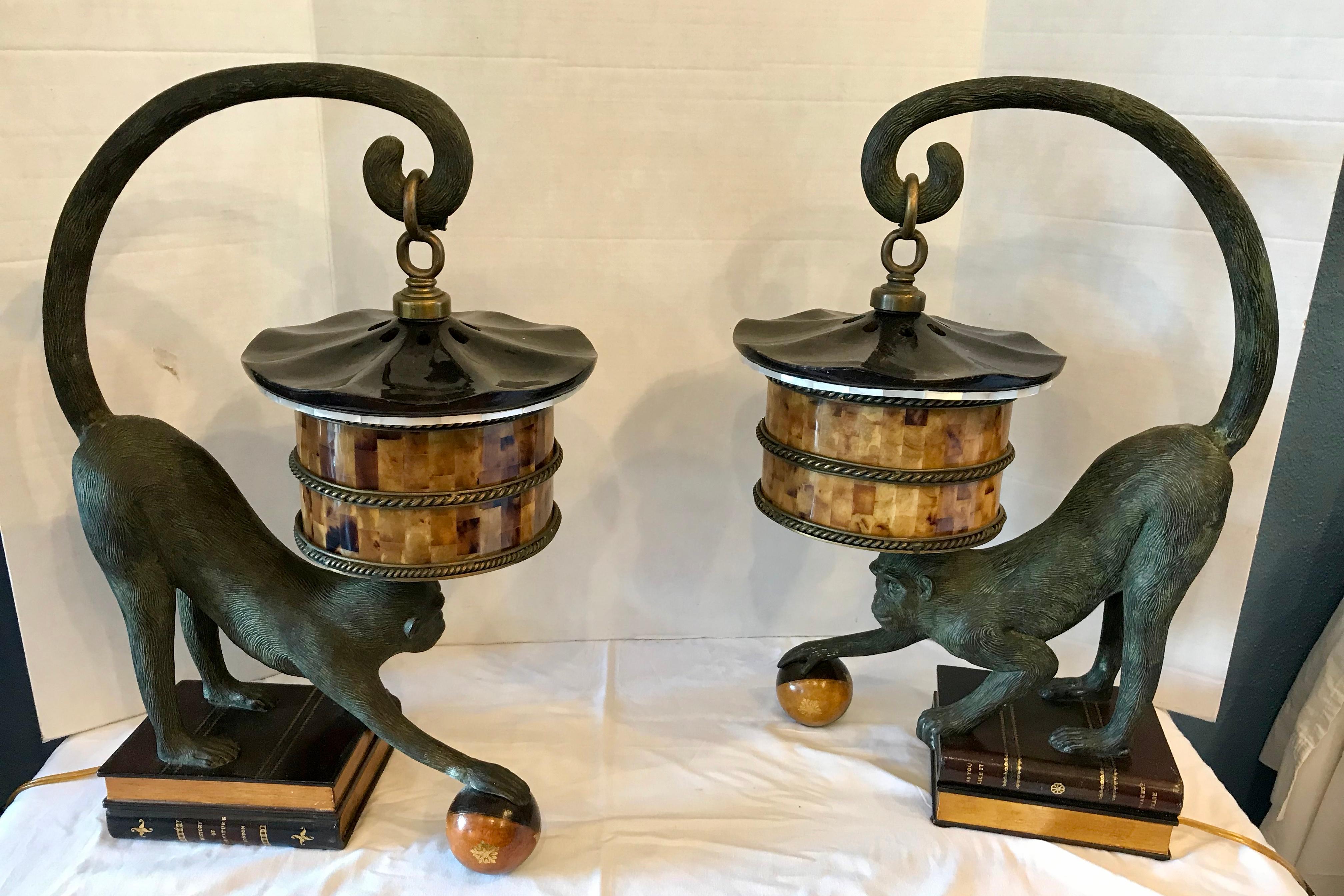 Whimsical Maitland Smith imports. The monkeys are post on faux books 
and are clutching spheres with their outstretched arms.
The shades are fashioned from horn.

 