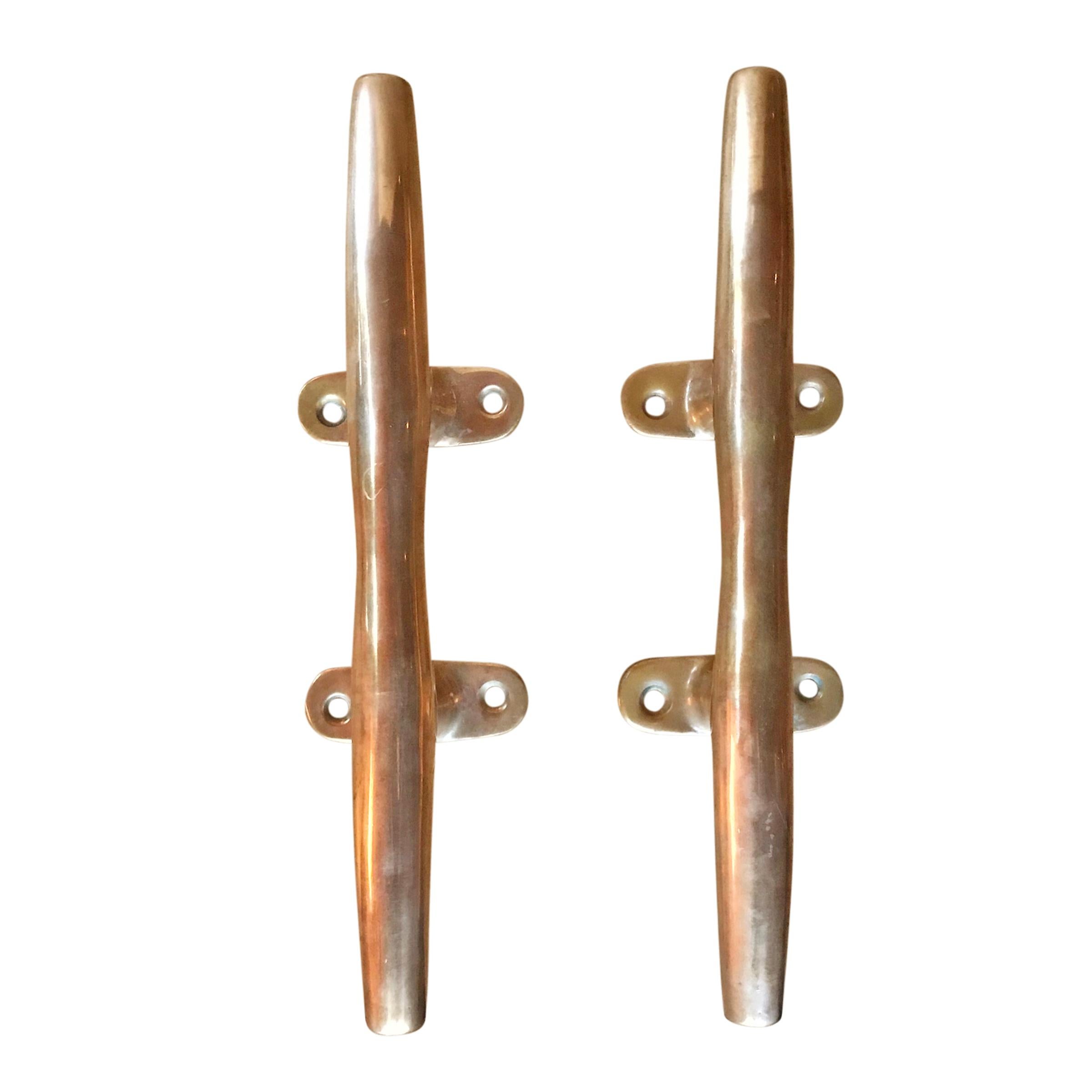 A pair of sculptural bronze mooring cleats originally used to moor a boat to a dock, but perfect for handles, towel bars, some other fanciful hardware application, or simply as sculpture.