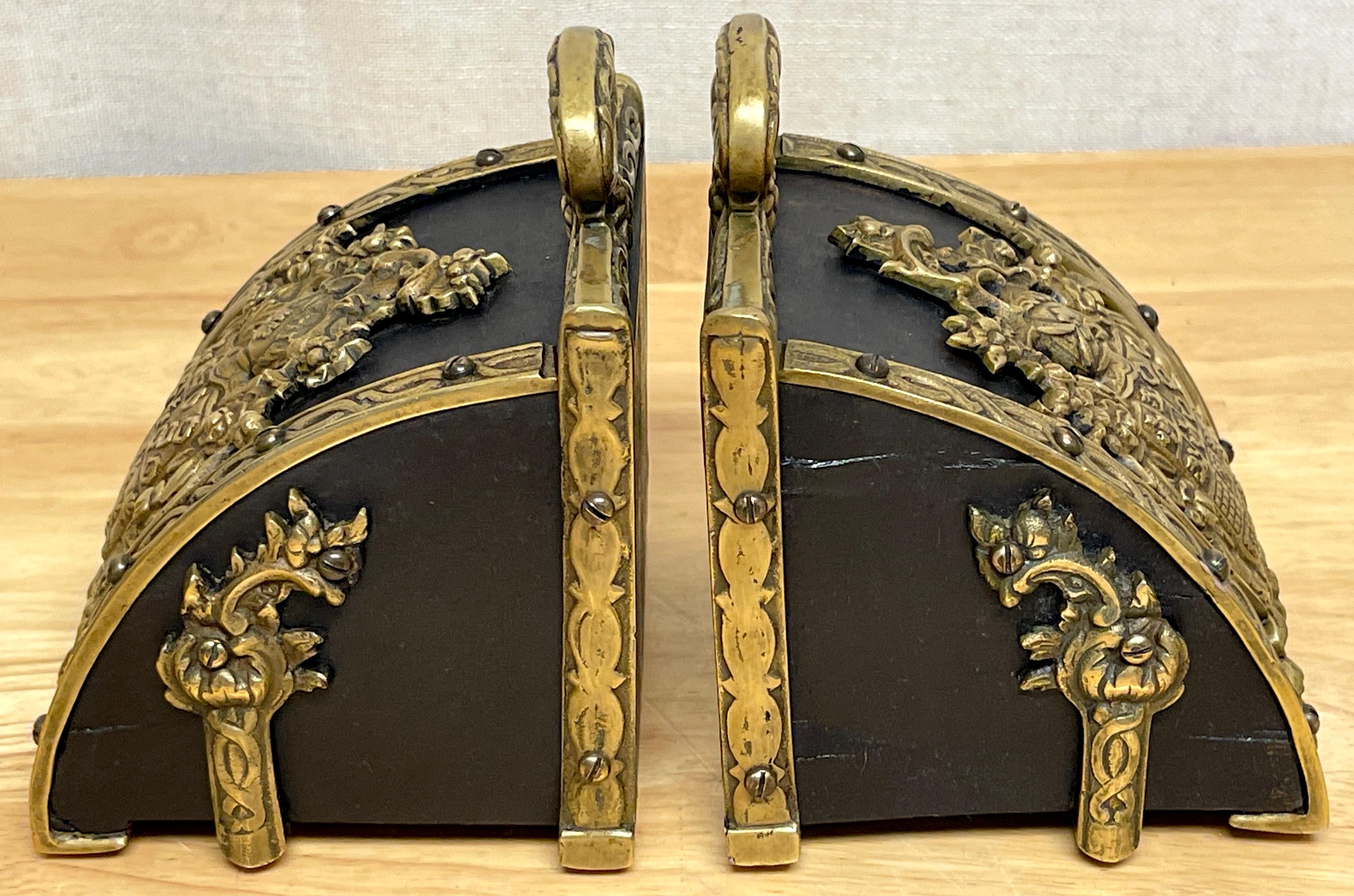 Pair of Bronze Mounted Armorial Motif Ebonized Wood Stirrup Motif Bookends 1